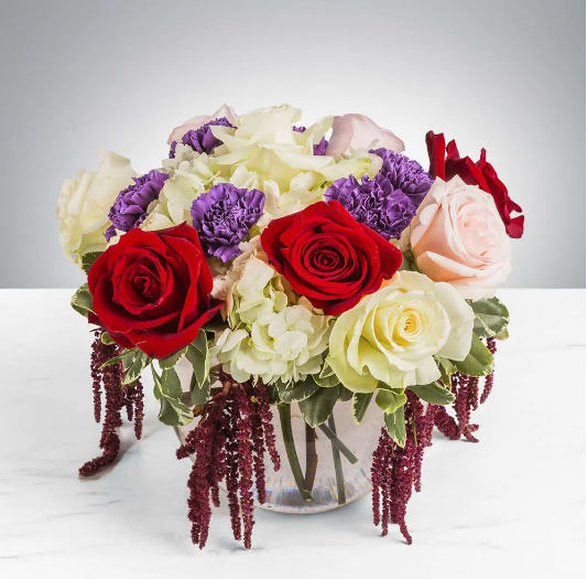 Modern Fairytale by BloomNation™ - Modern Fairytale by BloomNation™ is the perfect gift for a birthday, show gratitude, or romantic gesture.   Arrangement Details: Includes white roses, blush roses, red roses, white hydrangea, purple carnations, red hanging amaranthus, and seeded eucalyptus.  APPROXIMATE DIMENSIONS:10" H X 11" W