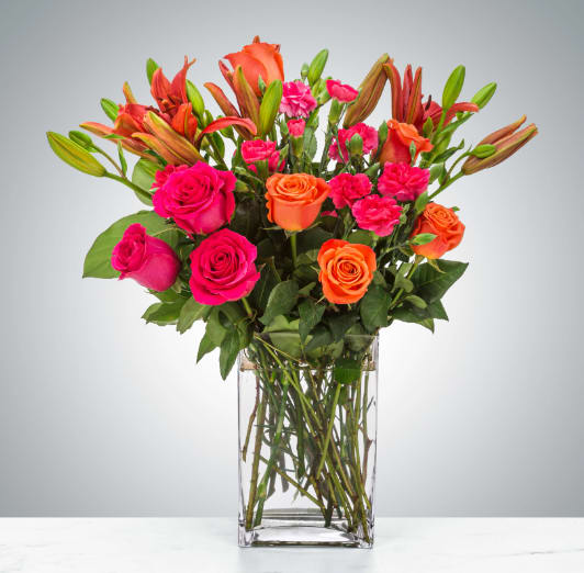 Boss Babe by BloomNation™ - This arrangement is electric! Send this bright orange and hot pink rose arrangement to make a big impression.  Approximate Dimensions: 20"D x 20"H