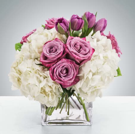 Here for You by BloomNation™ - Express your condolences after the loss of a loved one with flowers. Sending this clean purple and white arrangement featuring lavender roses and white hydrangea is a way to show you care and are thinking of them.  Approximate Dimensions: 11"D x 11"H