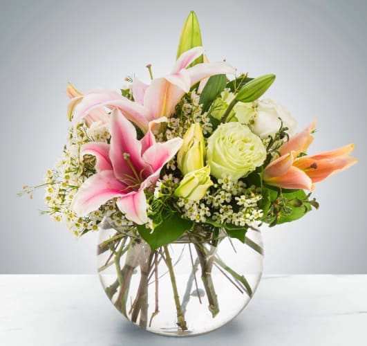 Polished Pearl by BloomNation™ - A beautiful bubble arrangement, featuring pink lilies, white and green roses, and more, this arrangement is the perfect all-occasion gift. Pearls are the birthstone of June making this a great option for an early summer birthday!  Approximate Dimensions: 10''D x 13''H