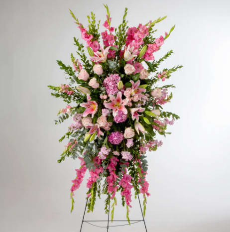Compassion by BloomNation™  - Pink roses, lilies, and more come together for a blushing pink standing funeral spray. 
