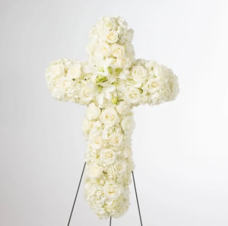 Faith by BloomNation™  - An all white tribute, this white cross funeral spray is pure and tranquil. Featuring a variety of white flowers, this elegant easel compliments the beauty of life. 