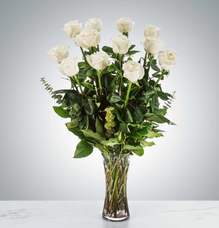 Dozen Long Stem White Roses by BloomNation™ - A dozen white roses are a classic gift! Perfect for Valentine's Day, an Anniversary, or any type of celebration.  Approximate Dimensions: 20"D x 30"H