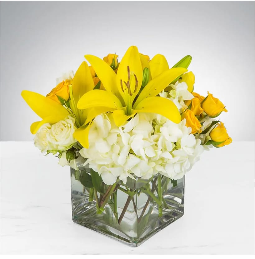 Kiss of the Sun by BloomNation™ - Bring the sunshine to someone's day with the gorgeous, fragrant bouquet. This arrangement contains asiatic lilies, spray roses, and hydrangea. It is the perfect gift for someone's birthday or to uplift someone's spirits. APPROXIMATE DIMENSIONS: 9"L X 9"W x 9"H