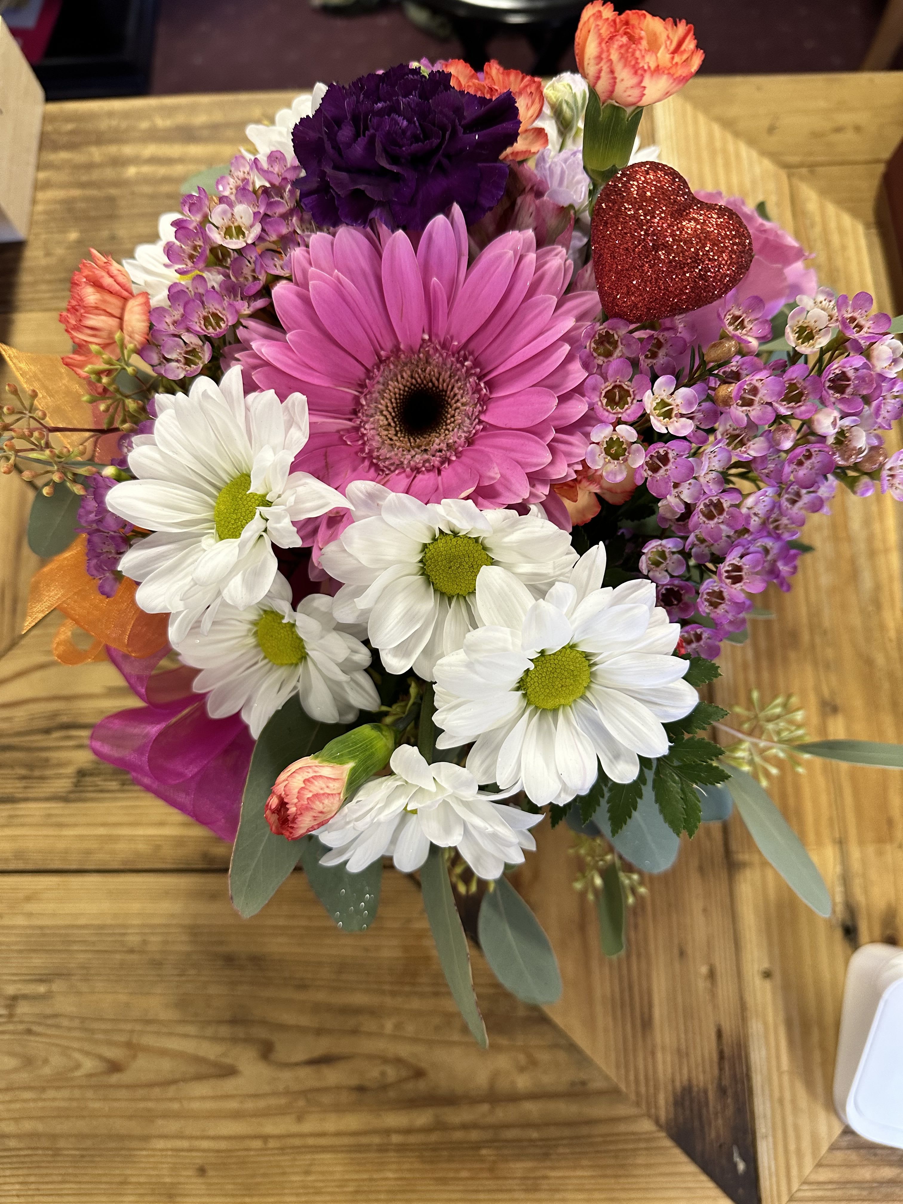 Mixed bouquet with pink gerbera, white daisies, and purple flowers