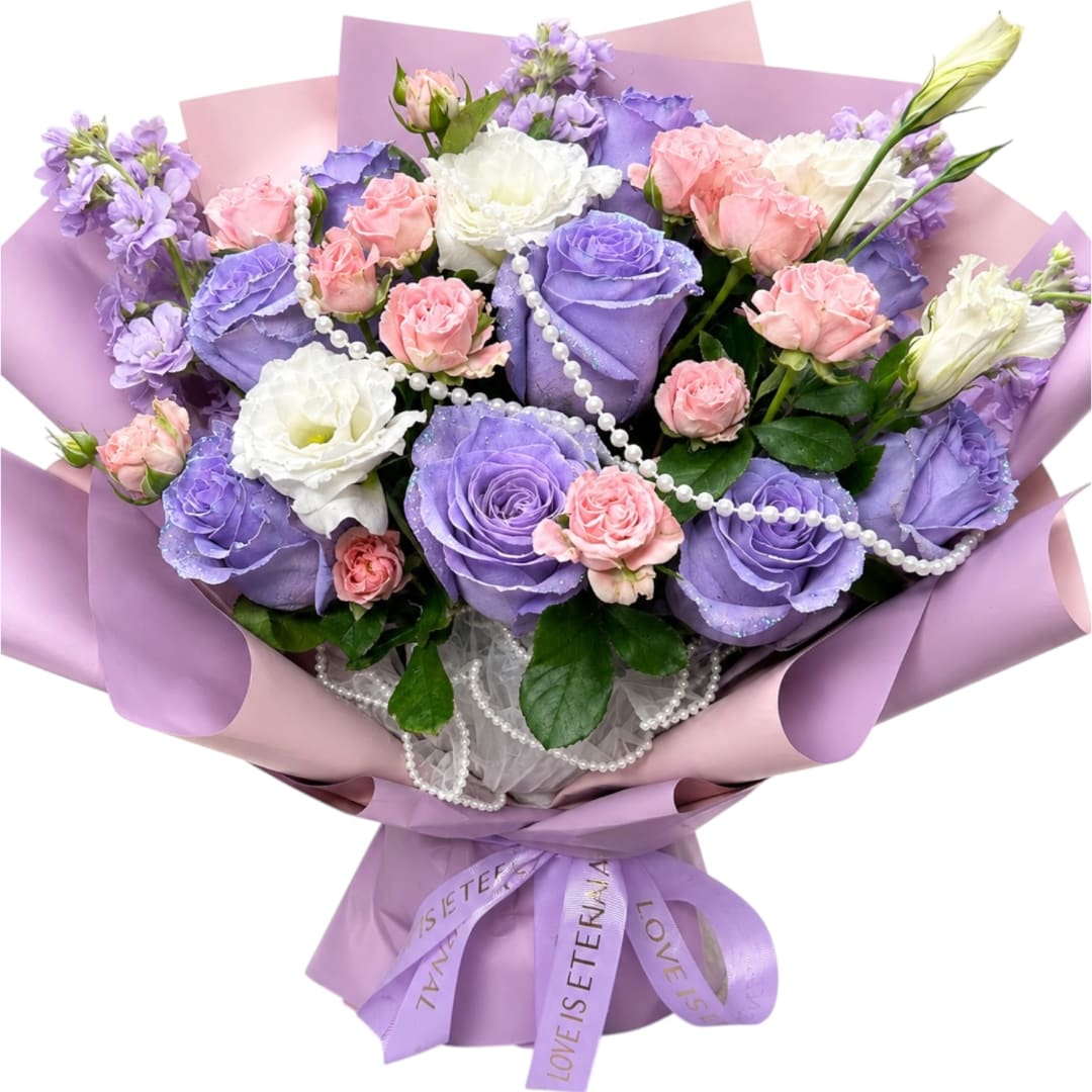 Bouquet of lavender and pink roses with white flowers wrapped in pastel paper