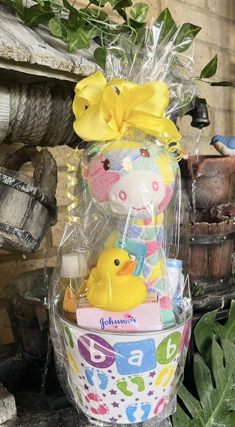 Baby gift basket with a plush toy, rubber duck, and toiletries