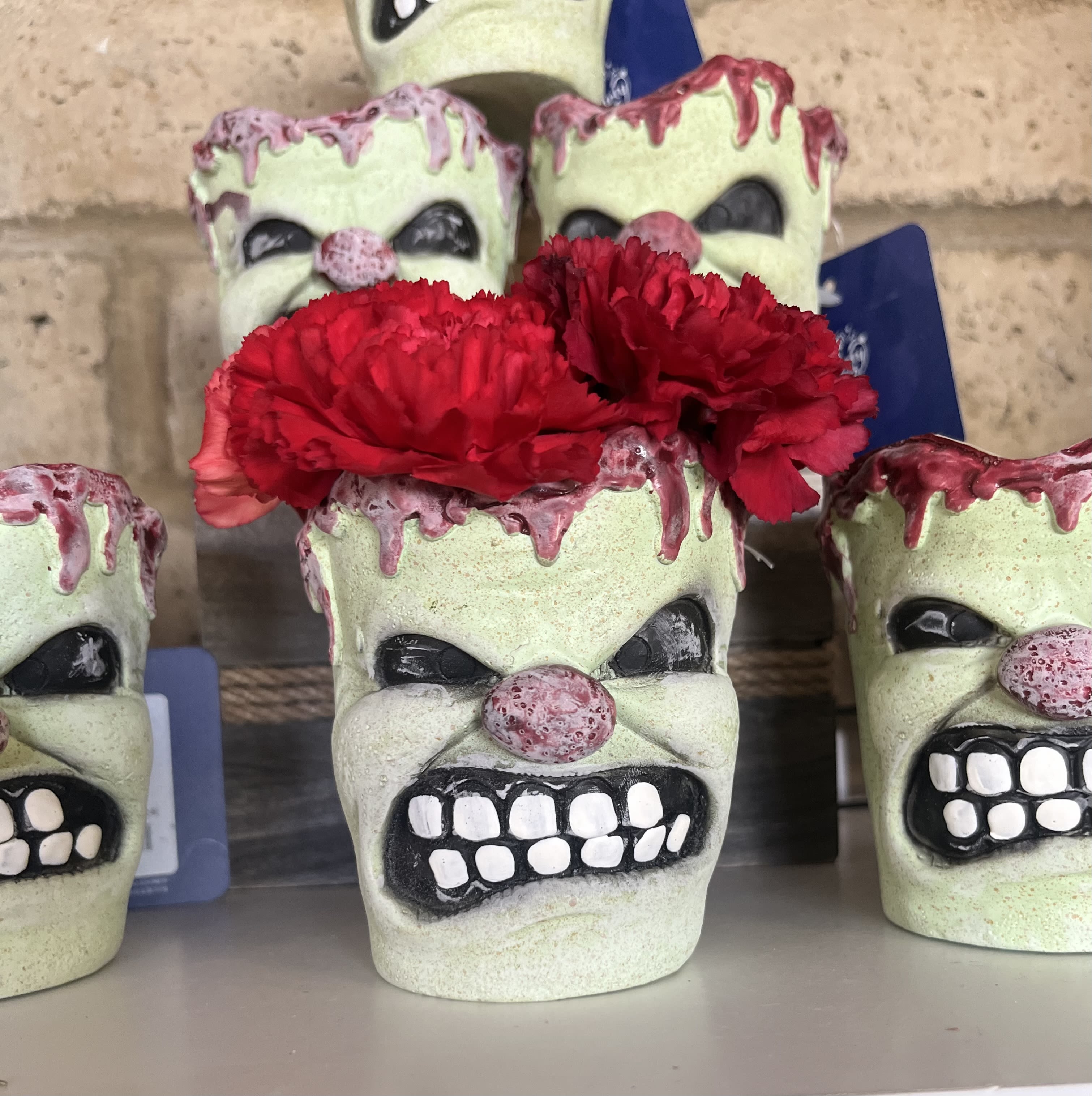 Red carnations arranged in a skull-shaped planter