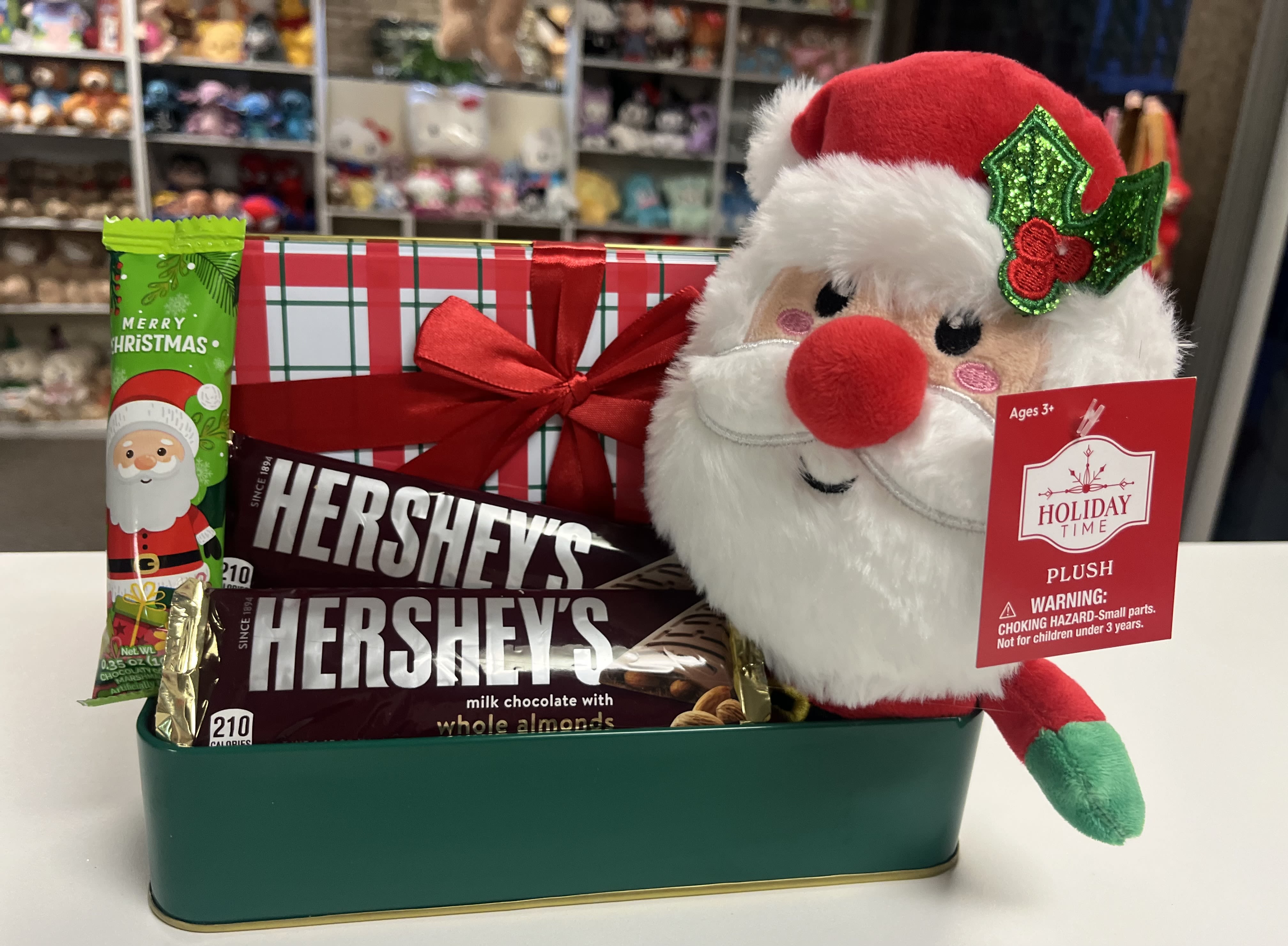 Christmas gift basket with candy bars and a Santa plush