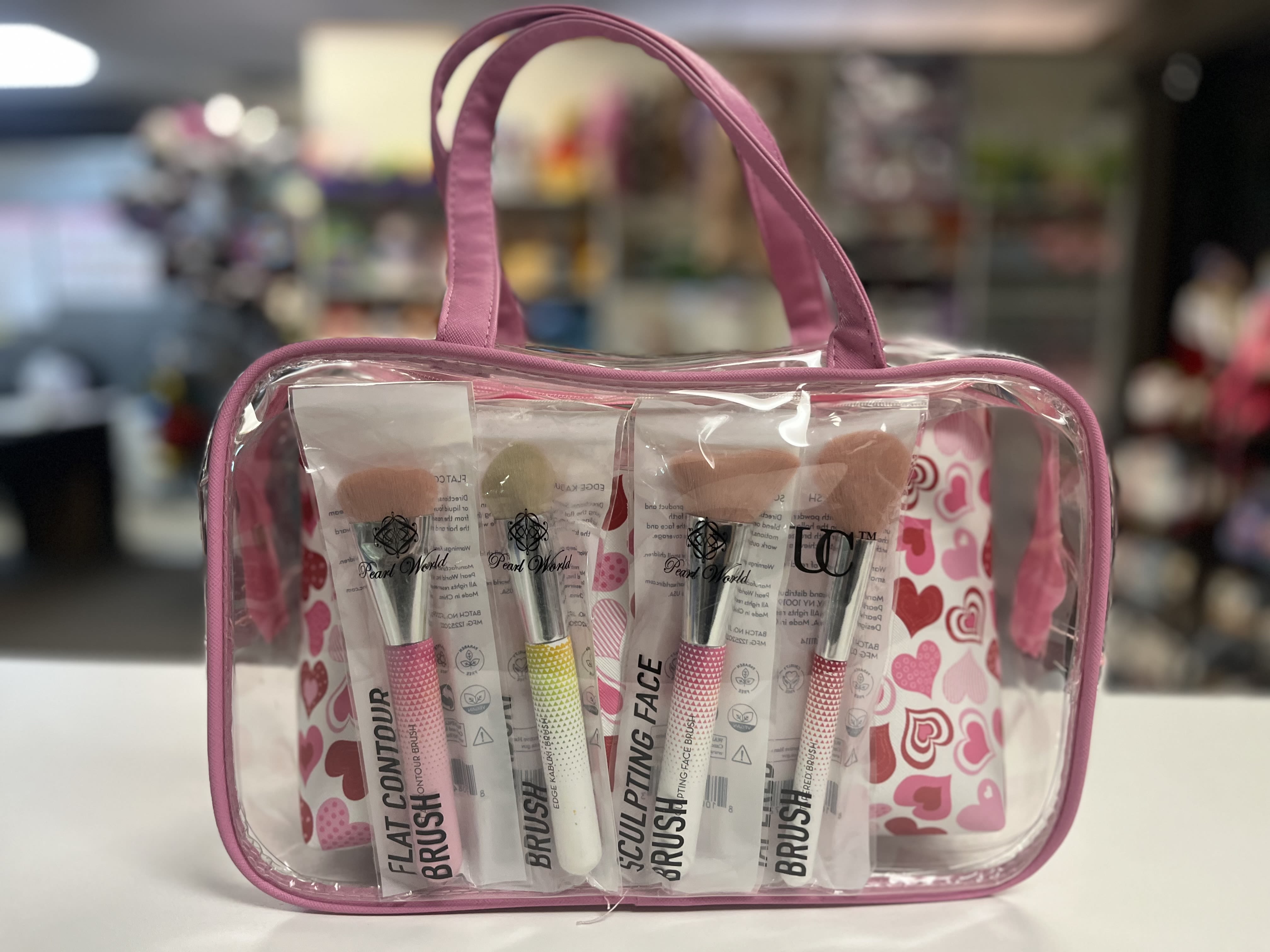 Pink cosmetic bag with four makeup brushes inside