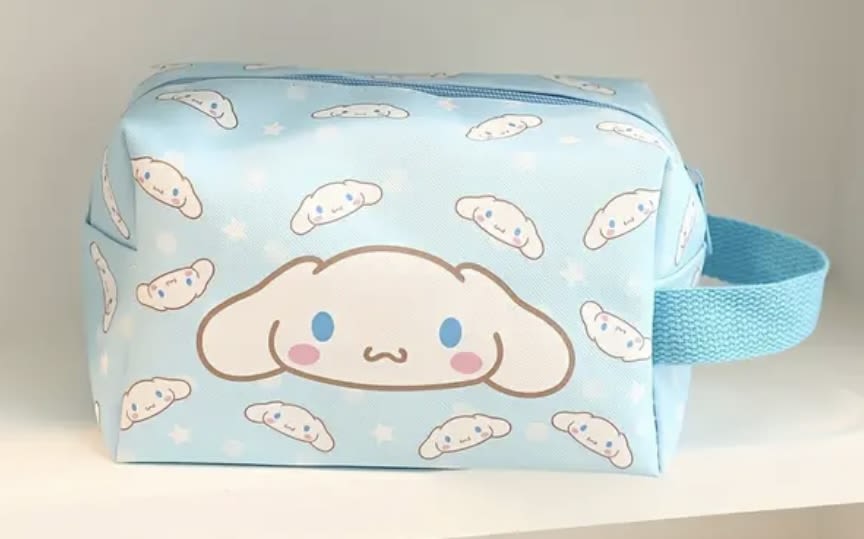 Light blue zippered pouch with a cartoon dog face pattern