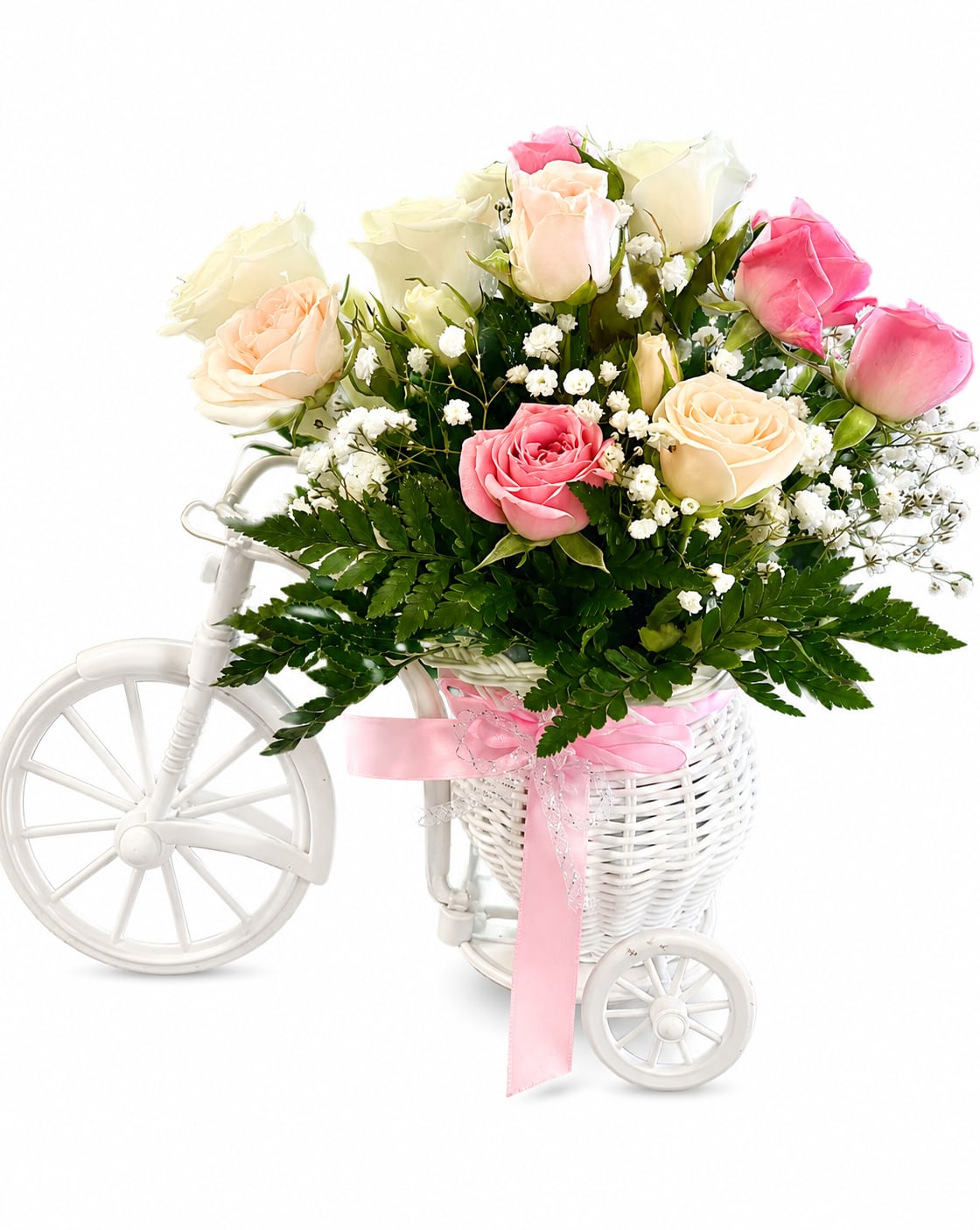 Pink and cream roses in a white tricycle basket with a pink ribbon