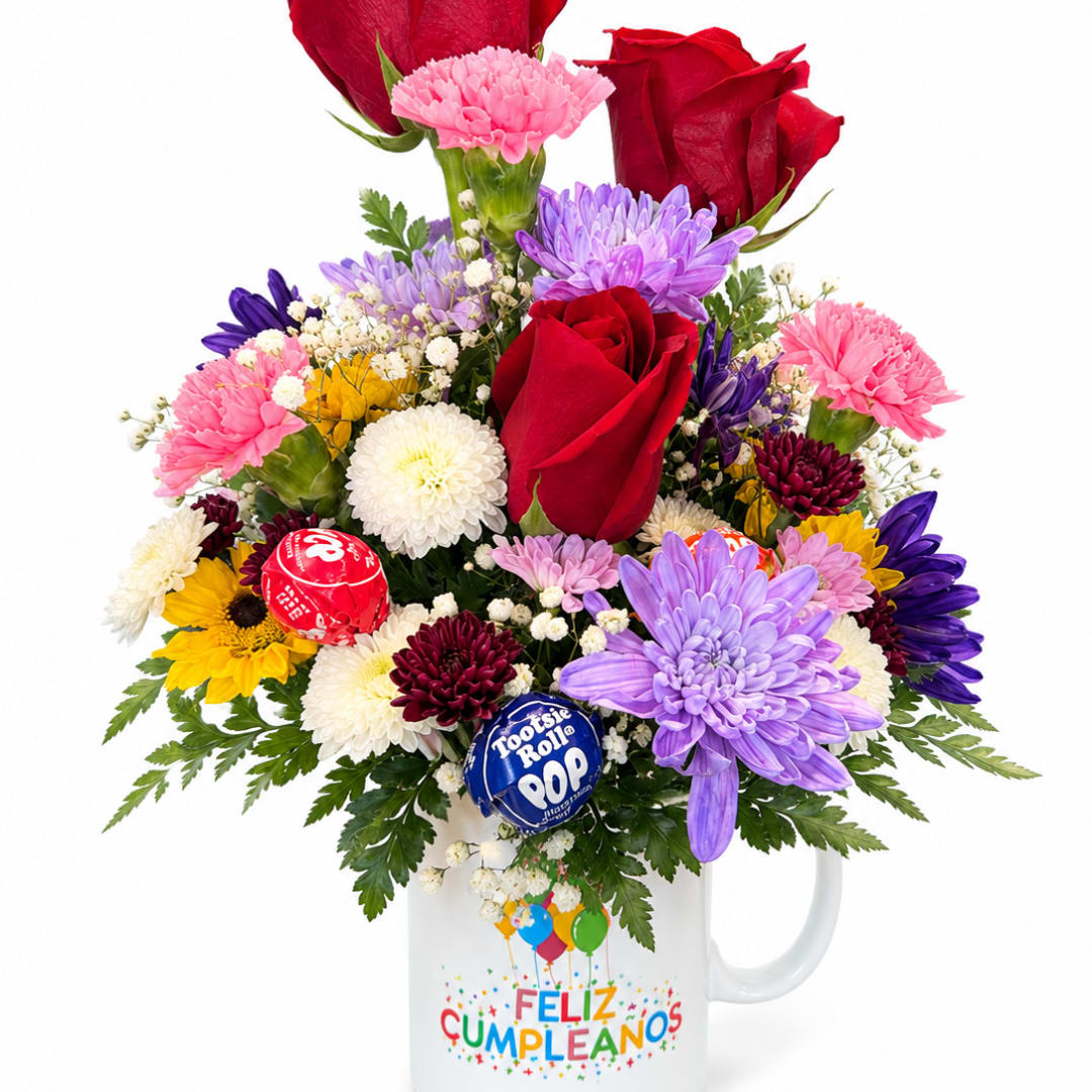 Mixed bouquet of roses and chrysanthemums in a mug with candy lollipops
