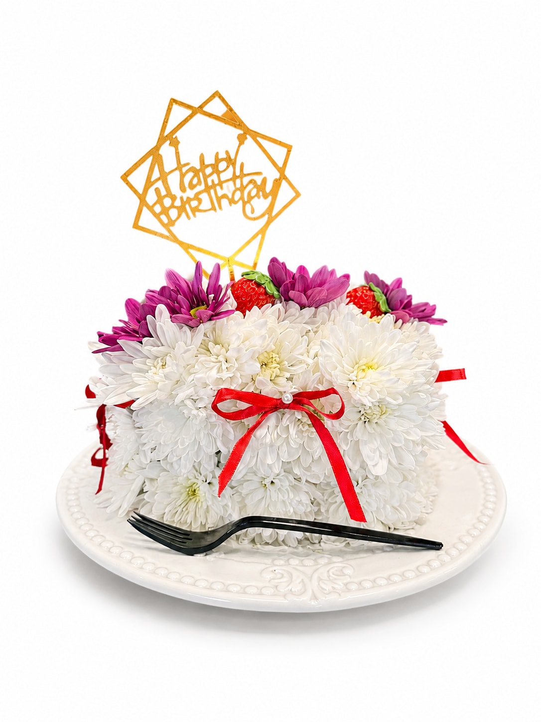 White chrysanthemum cake with purple flowers and a gold happy birthday topper