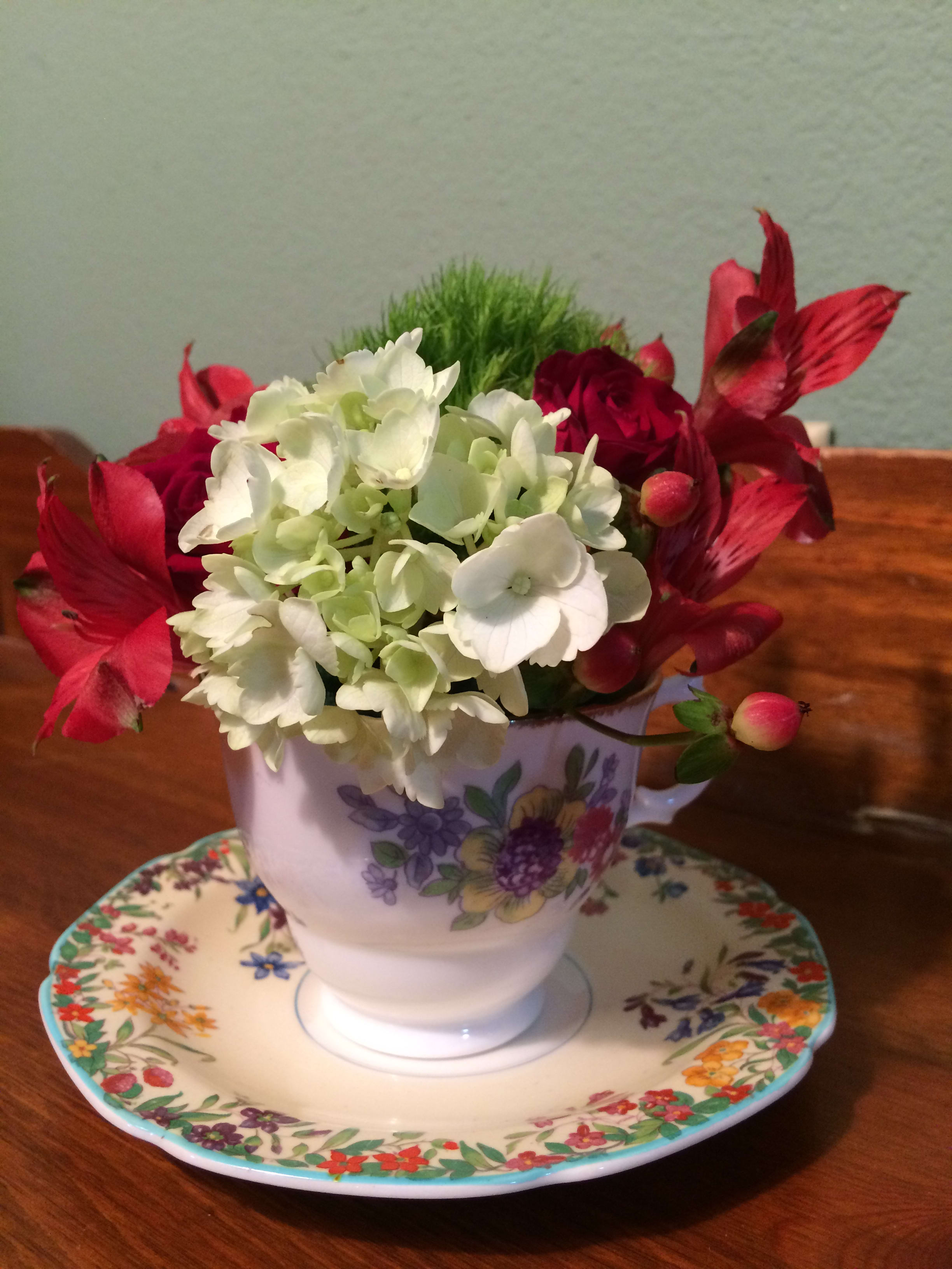Vinage Teacup - Our Vintage Bone China Teacup Floral arrangement includes a cup with matching saucer.  We will fill with our freshest seasonal blooms that match the mood of the set. Tea cup &amp; saucer may vary from picture shown. Each 2-piece set is unique. (made in England or China) Not suitable to food or drink. Display only. Substitution Policy In some instances, the florists photo may represent an overall theme or look and include a one-of-a-kind vase which cannot be exactly replicated. Although the actual bouquet may not precisely match the photo, its temperament will. Occasionally, substitutions of flowers or containers happen due to weather, seasonality and market conditions which may affect availability. If this is the case with the gift you've selected, the local florist will ensure that the style, theme and color scheme of your arrangement is preserved and will only substitute items of equal or higher value.