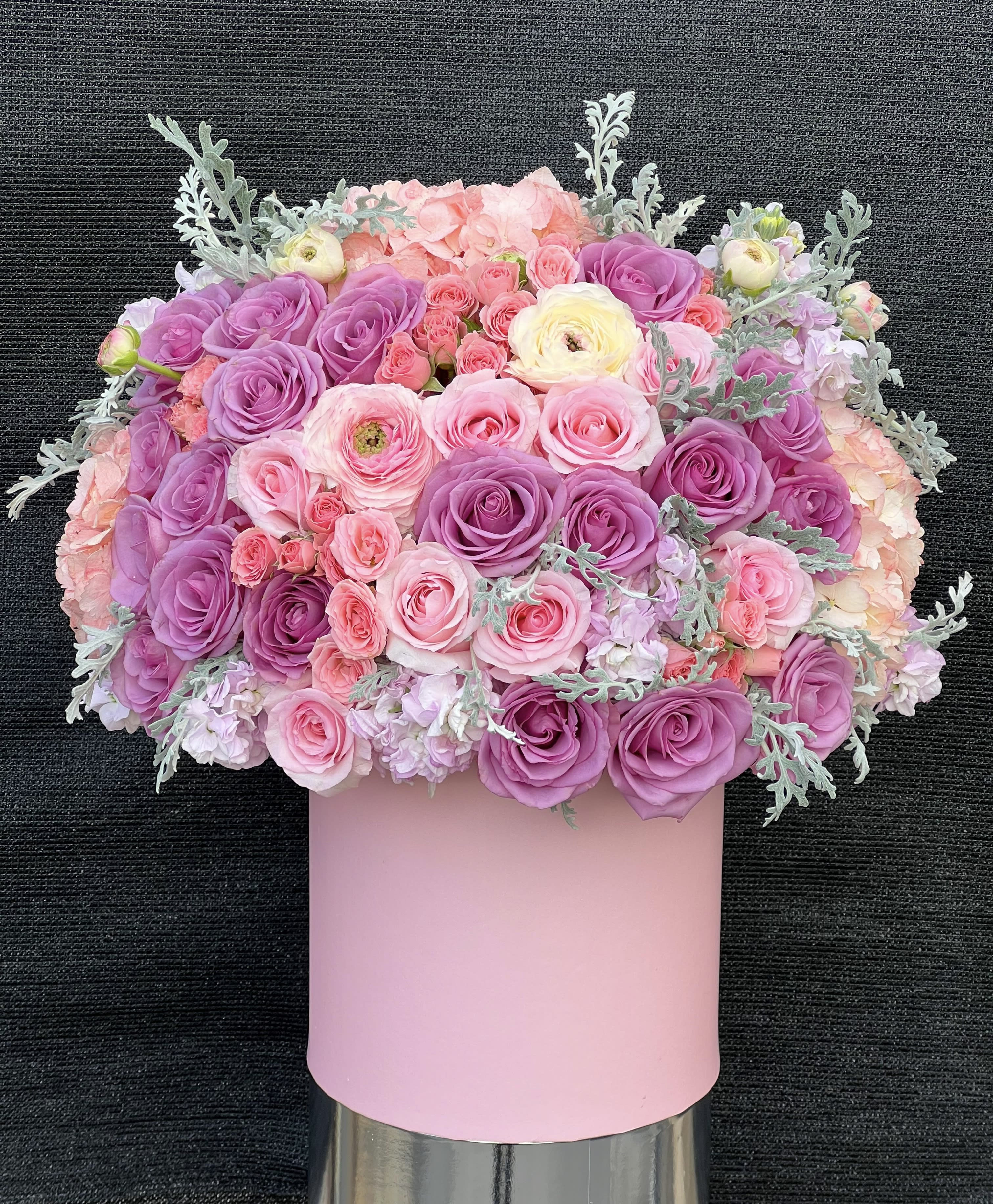 Pink and purple rose bouquet in a pastel pink box