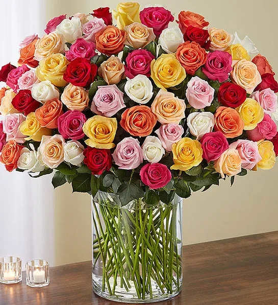 Large bouquet of multicolored roses in a clear glass vase