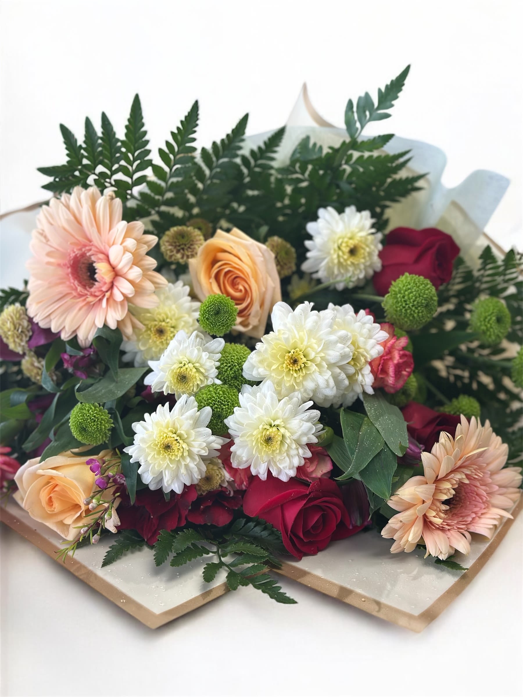 Bouquet of roses, gerbera daisies, and white chrysanthemums