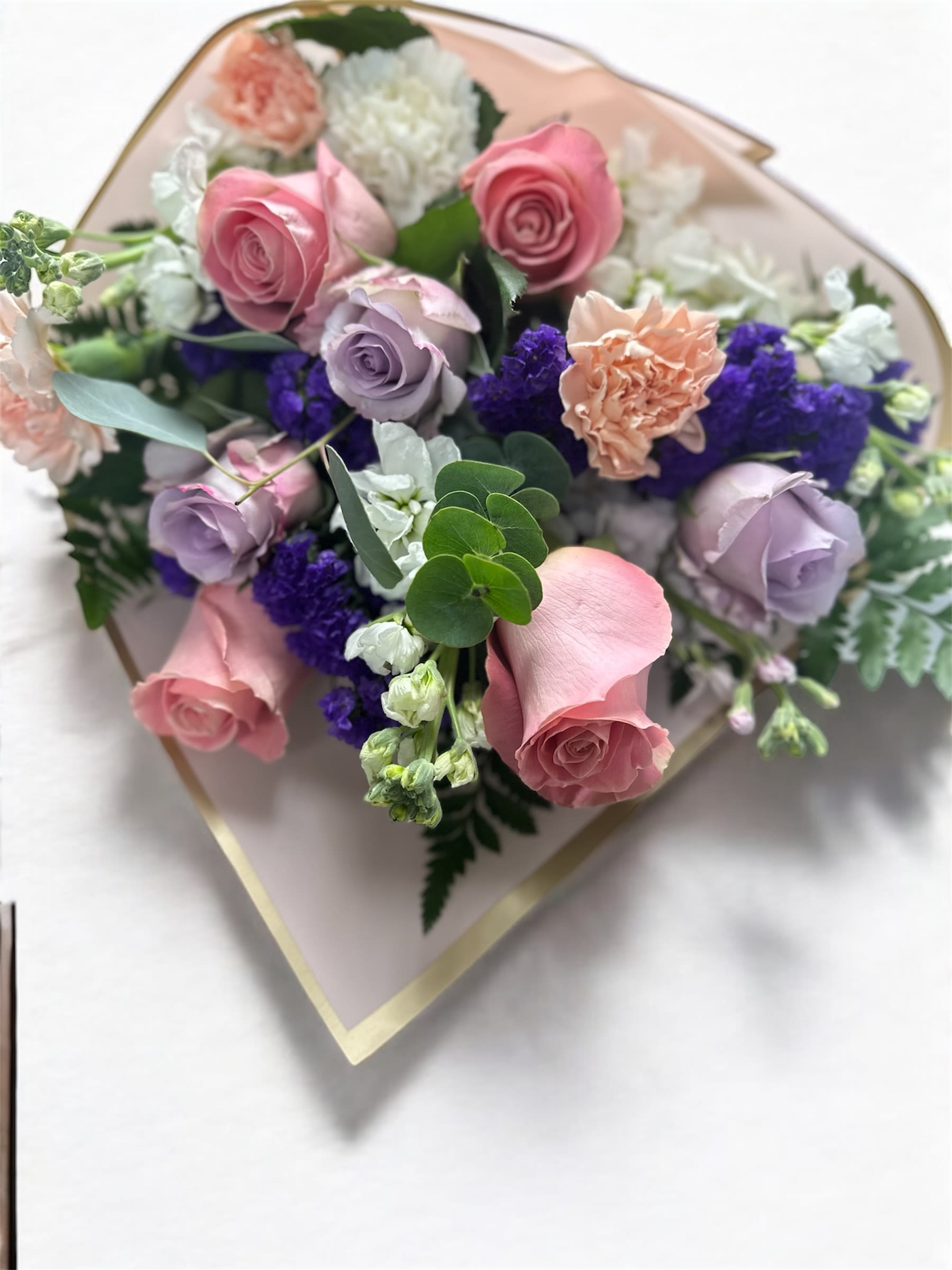 Bouquet of pink and lavender roses with white and purple filler flowers
