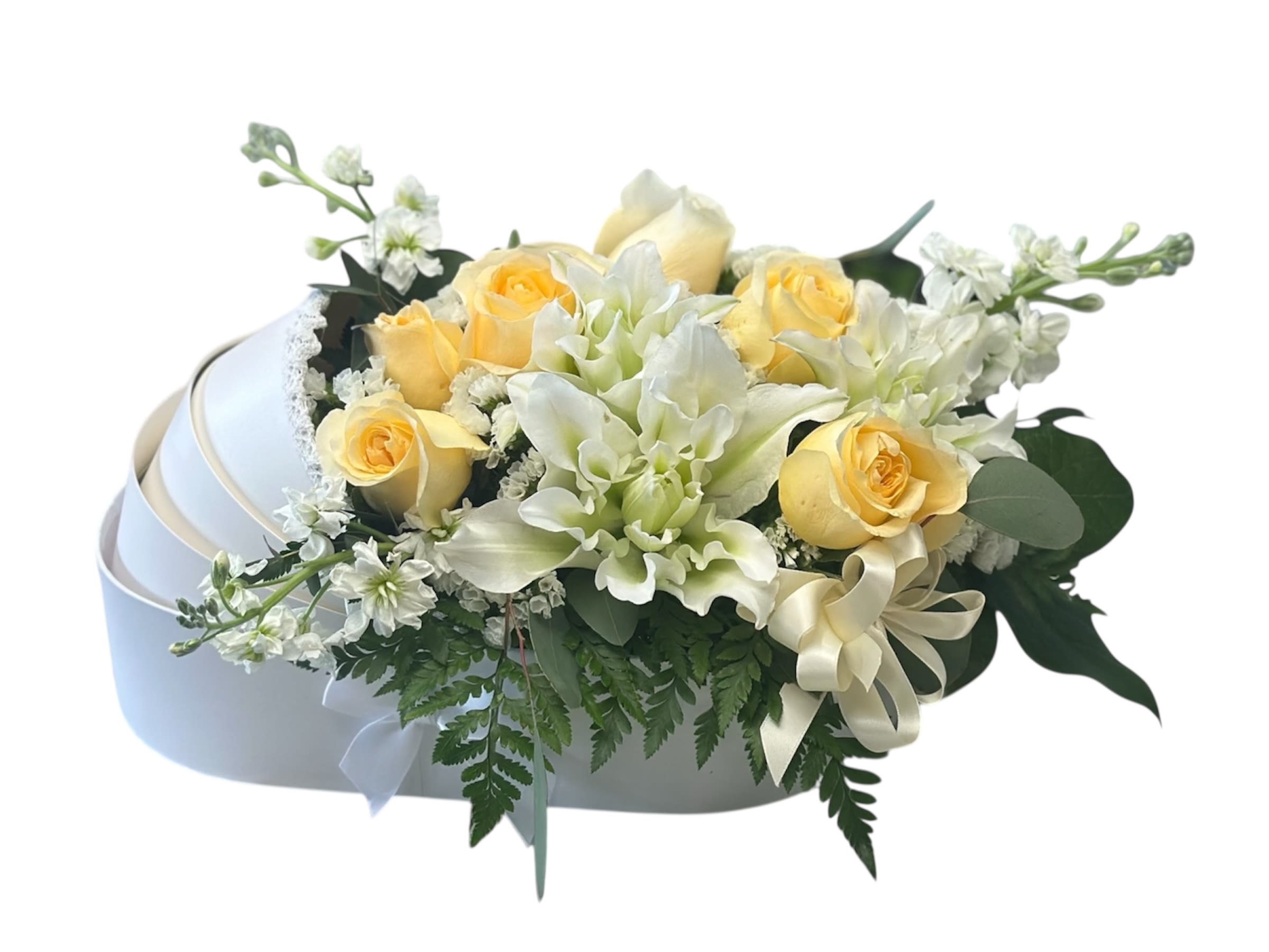 Yellow roses and white flowers in a white hatbox with a ribbon bow