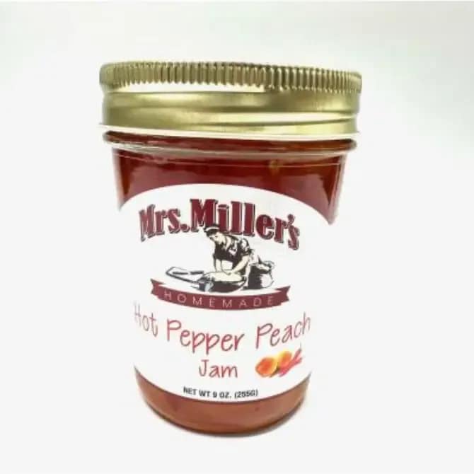 Jar of Mrs. Miller's hot pepper peach jam with a gold lid