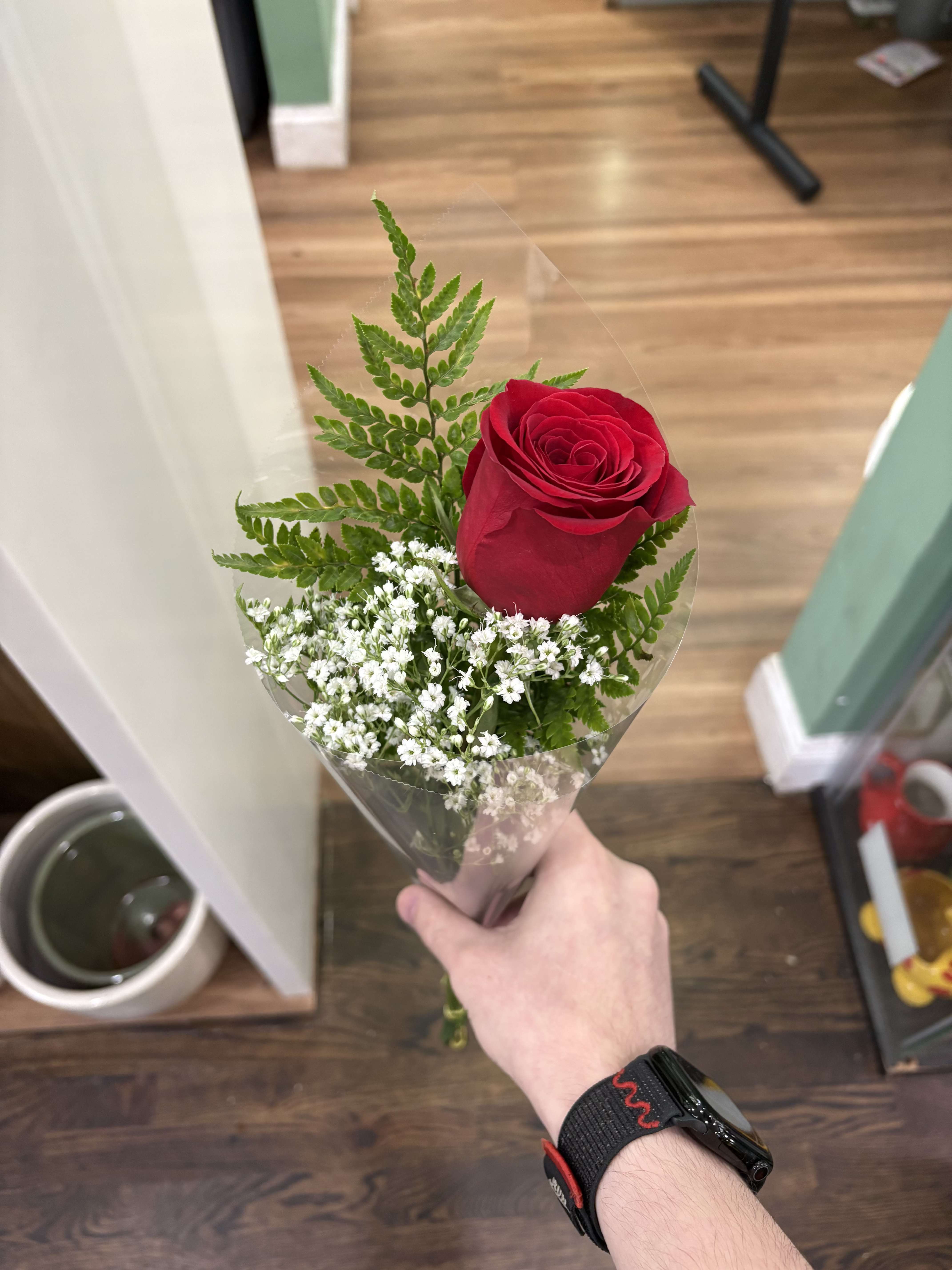 Individually wrapped Rose (Any Color Except Blue) - This item consists of an individually wrapped rose of any color, with some baby's breath and greenery. (Available in any color except blue)