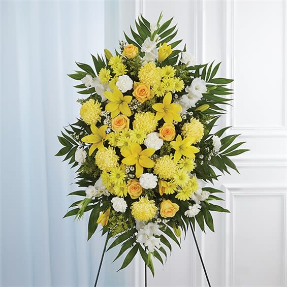 Yellow &amp; White Sympathy Standing Spray - A ray of hope can mean everything after the loss of a loved one. Both bright and abundant, our impressive standing spray arrangement, meticulously handcrafted by expert local florists with sunny yellow and rich white blooms, offers a grand gesture of peace, comfort and light during a difficult time.  •Standing spray arrangement with yellow roses and daisy poms; white yellow Asiatic lilies , gladiola, yellow football mums , carnations and monte casino; accented with soft, lush greenery •Large measures approximately 56"H x 38"L without stand  •Medium measures approximately 46"H x 34"L without stand  •Small measures approximately 42"H x 30"L without stand  •Arrives on an easel  •Appropriate for the funeral home or gravesite  •Our florists use only the freshest flowers available, so colors and varieties may vary due to local availability