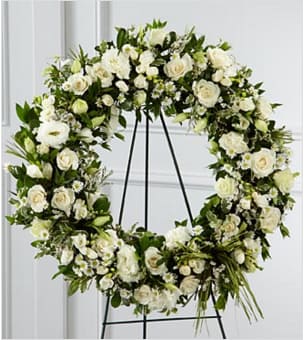 Splendor™ Wreath - Splendor™ Wreath is a symbol of lasting love and kinship, whether for the deceased or in comfort of those suffering from a loss. Elegant white freesia, double lisianthus, spray roses, Monte Casino asters and limonium are accented with a variety of lush greens and green raffia ribbon, perfectly arranged in the form of a wreath, to create a beautiful way to display your sincere sentiments. Approximately 20-inches in diameter. Your purchase includes a complimentary personalized gift message.