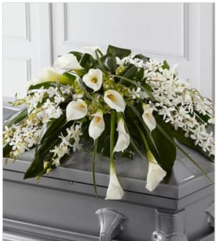 Angel Wings™ Casket Spray - Angel Wings™ Casket Spray is an exceptionally gorgeous way to bring peace and beauty to their final farewell service. White Dendrobium orchids, white calla lilies, green hydrangea and a variety of lush greens are artfully arranged to perfectly adorn the top of their casket, offering the colors and ambience of grace and serenity. Approximately 36"W x 22"D. Your purchase includes a complimentary personalized gift message.