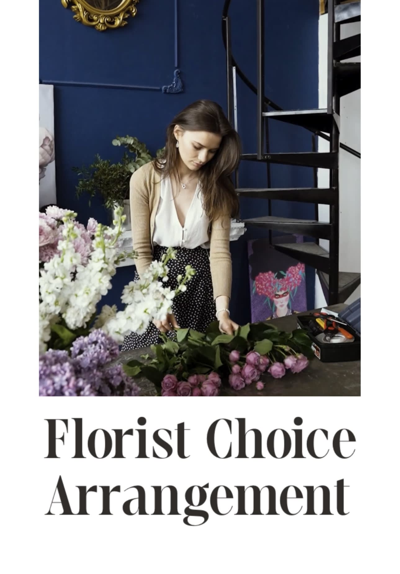 Florist arranging pink and white flowers on a table
