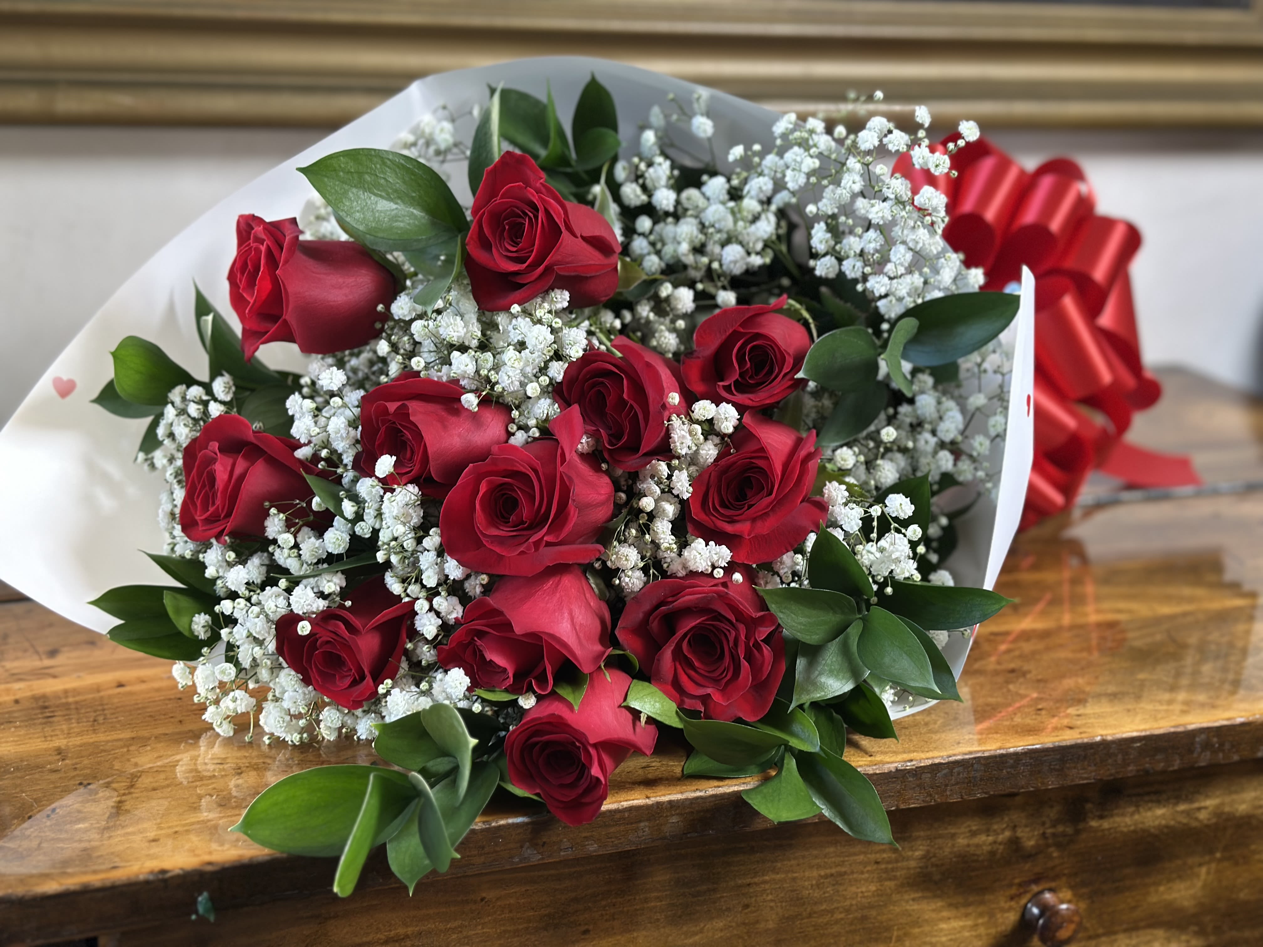 Bouquet of red roses with white baby's breath and a red ribbon
