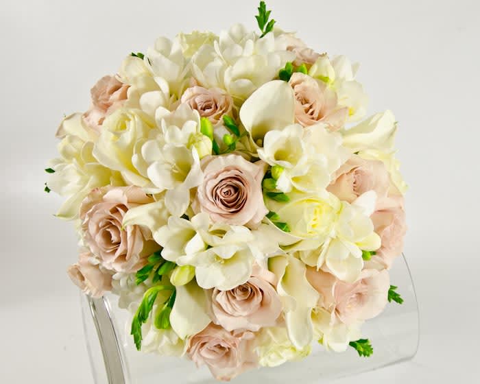 Bouquet of cream and blush flowers with green accents