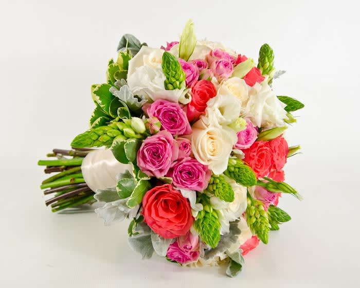 Bouquet of pink, red, and white roses with green accents