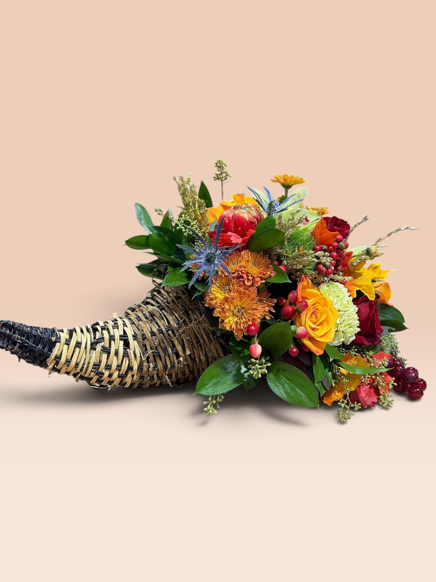 Horn-shaped basket filled with colorful flowers and berries
