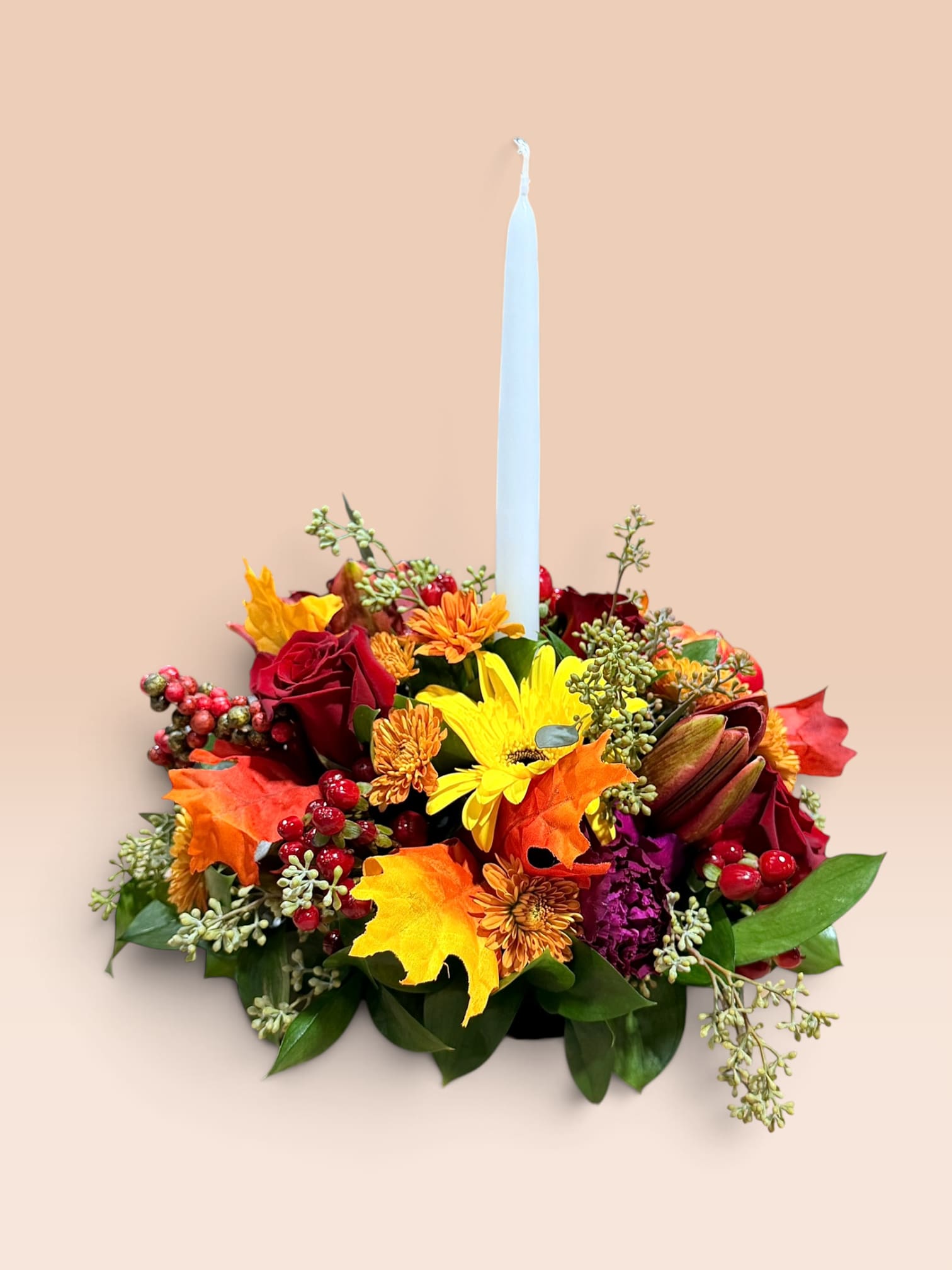 Autumn floral centerpiece with a tall white taper candle