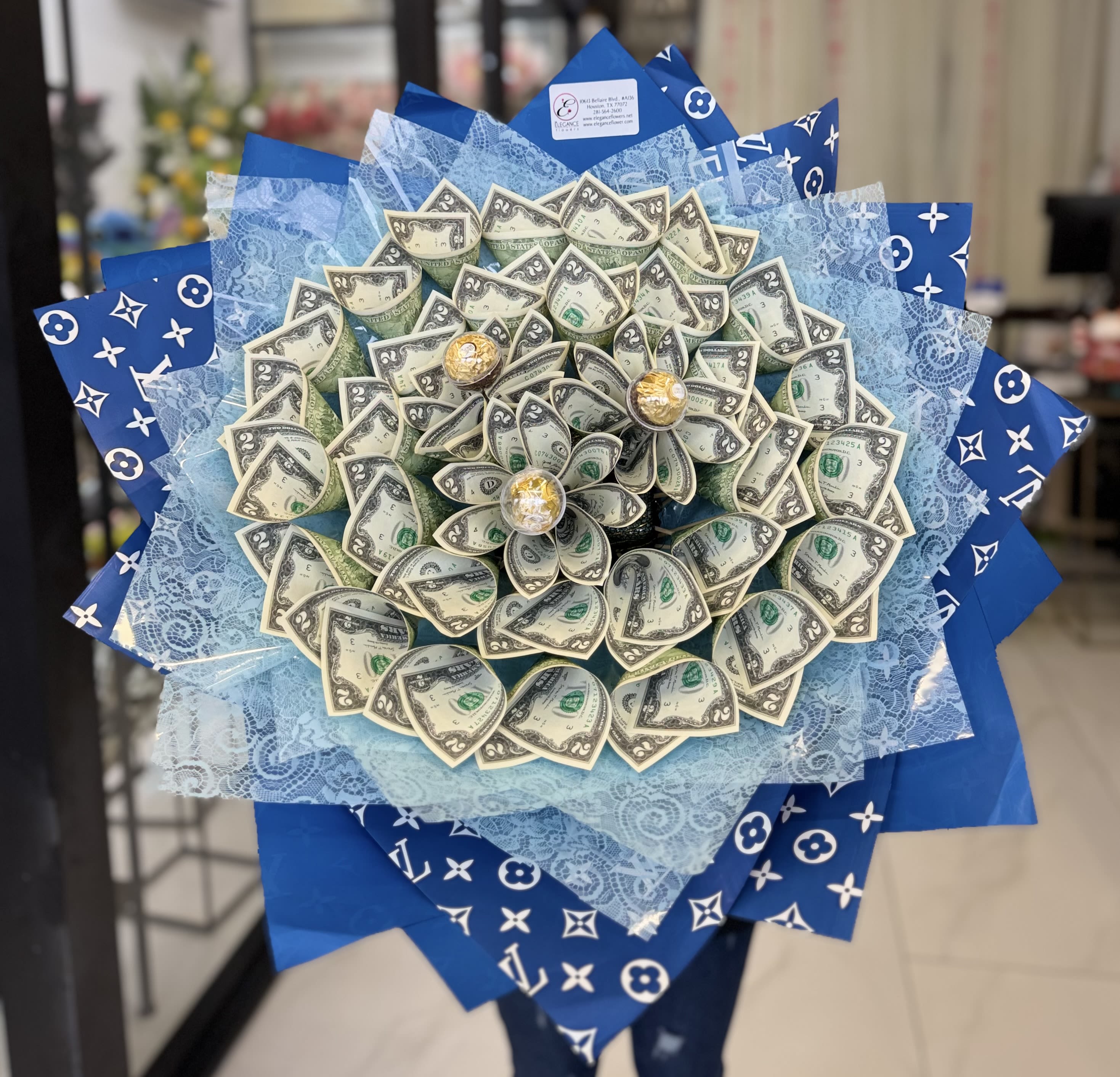 Bouquet made of folded dollar bills with blue wrapping