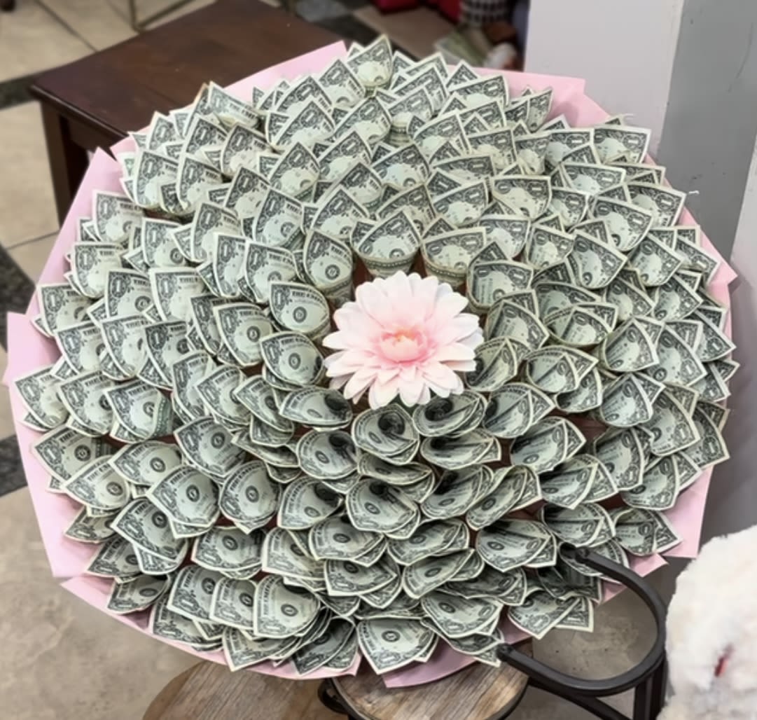 Bouquet made of folded dollar bills with a pink flower center