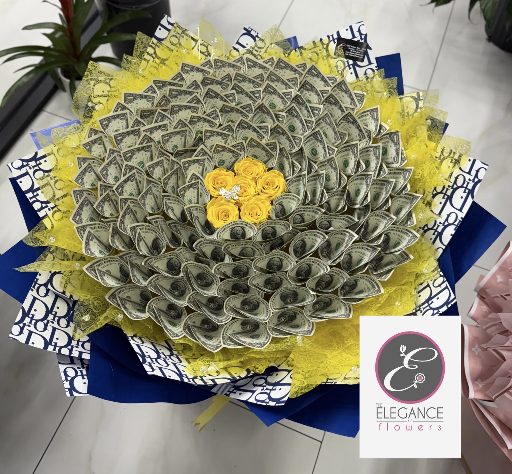 Bouquet made of folded dollar bills with yellow roses in the center
