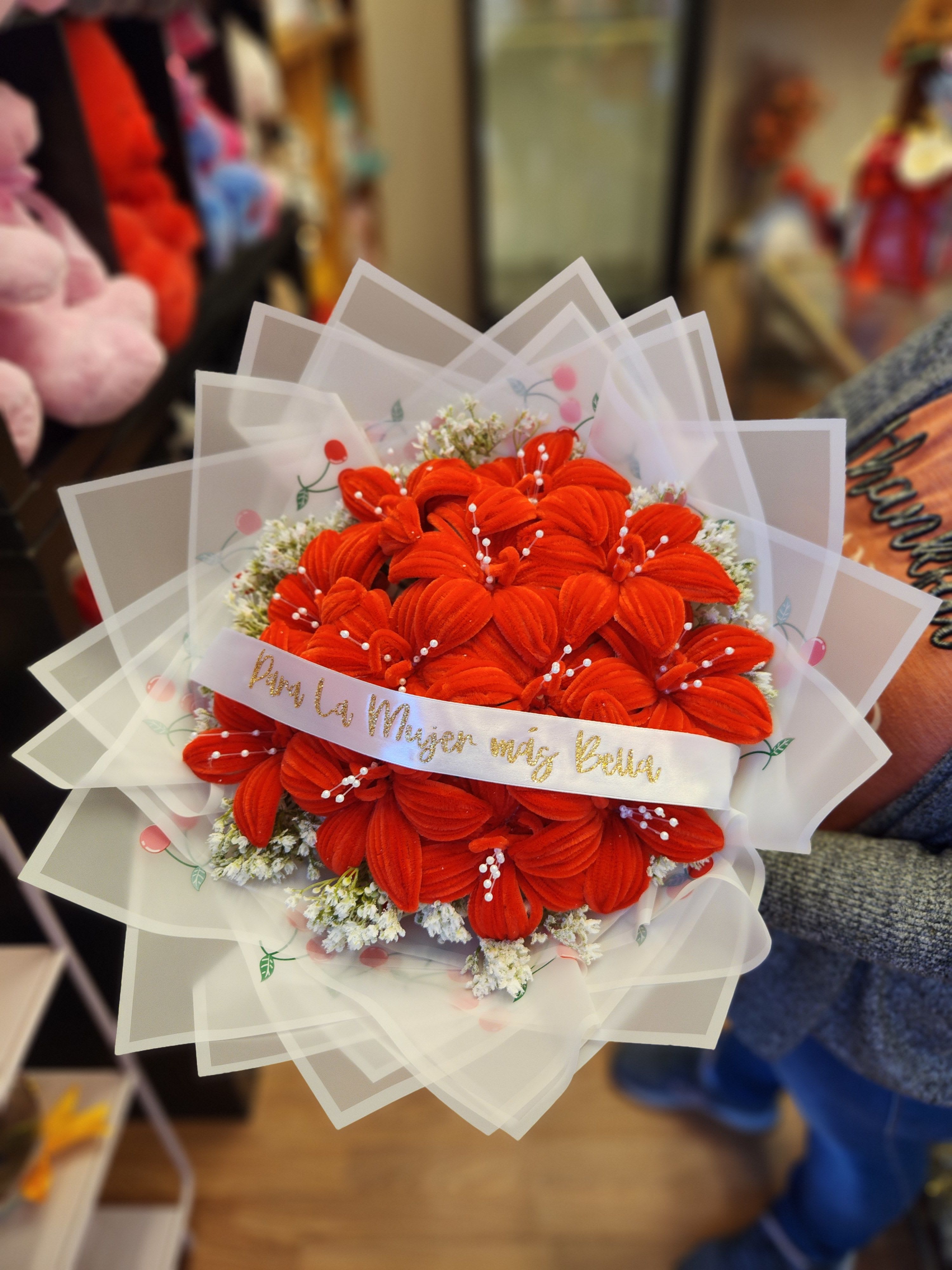 Bouquet of bright orange flowers wrapped in translucent paper