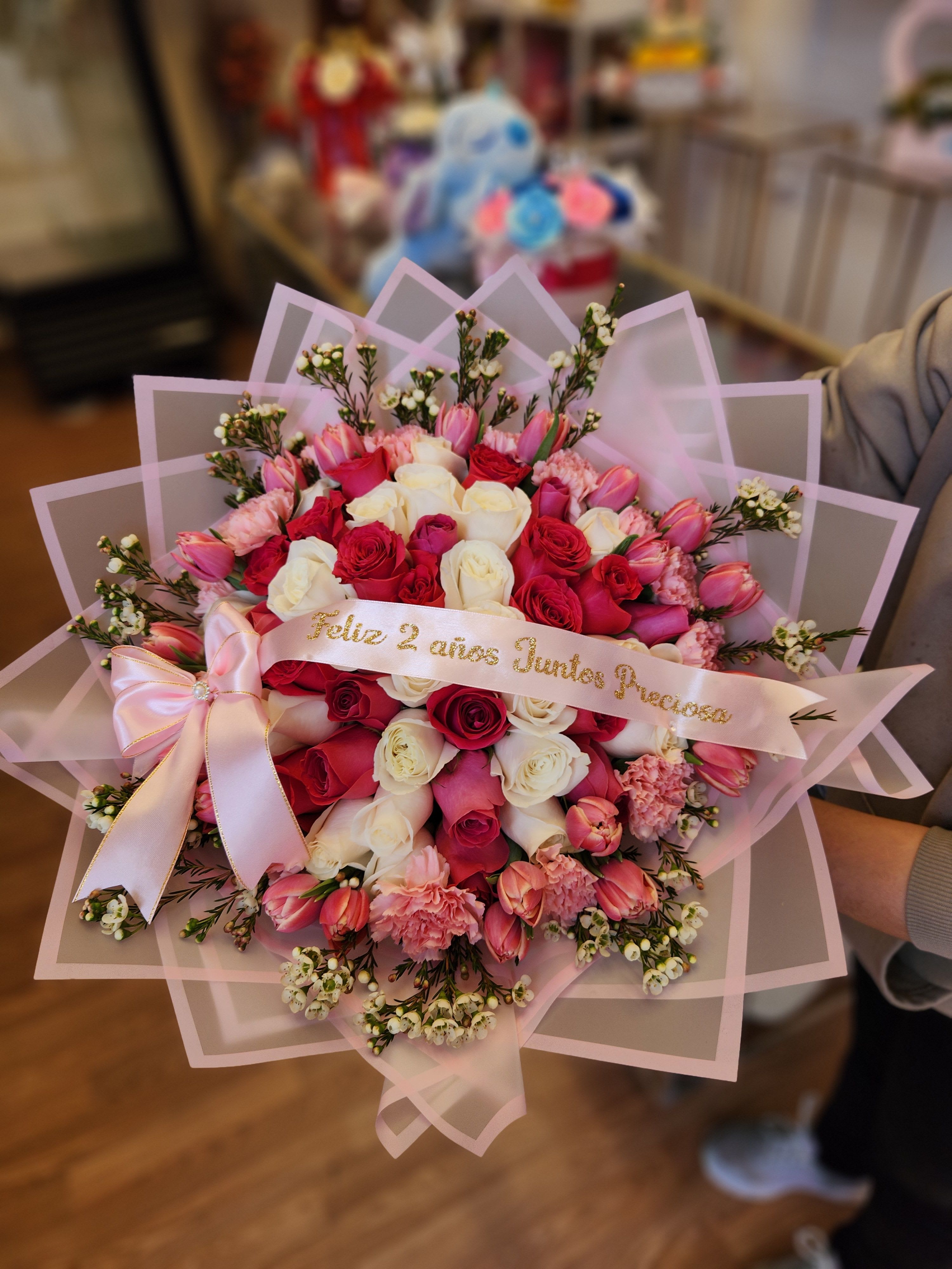 Pink and white rose bouquet with a satin ribbon and pink wrap