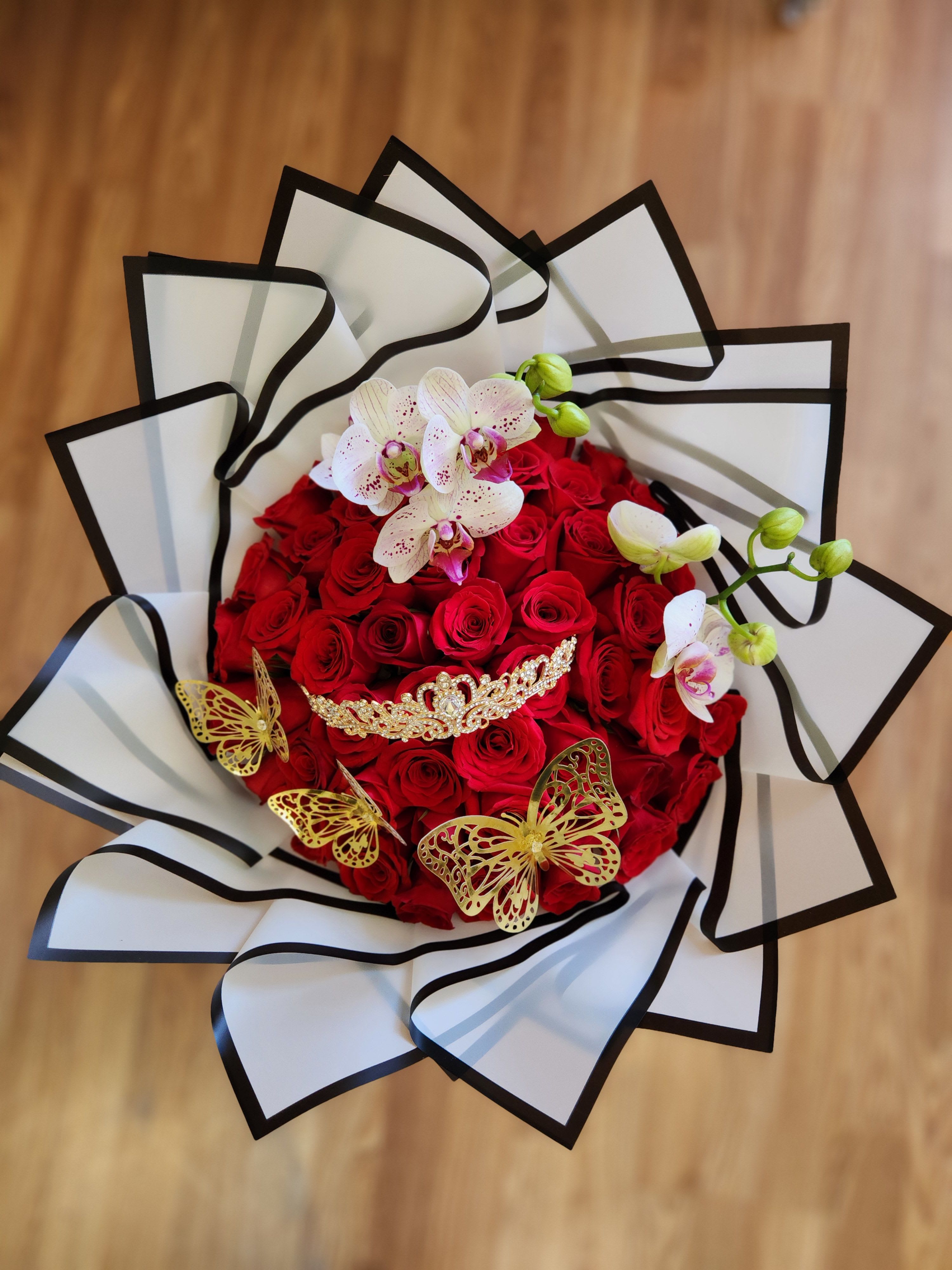 Red rose bouquet with white orchids and gold butterfly accents