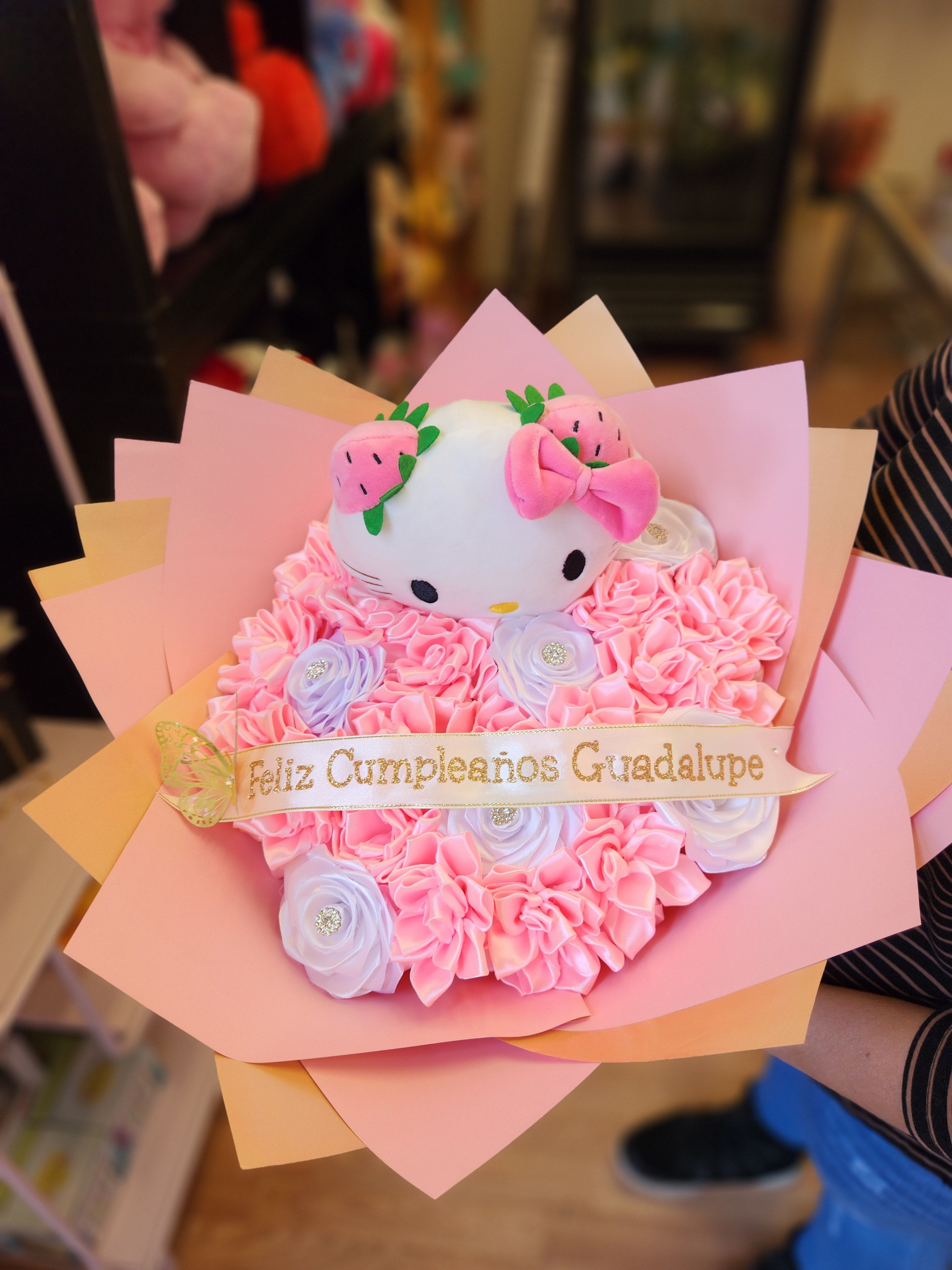 Pink bouquet with a Hello Kitty plush and a birthday ribbon
