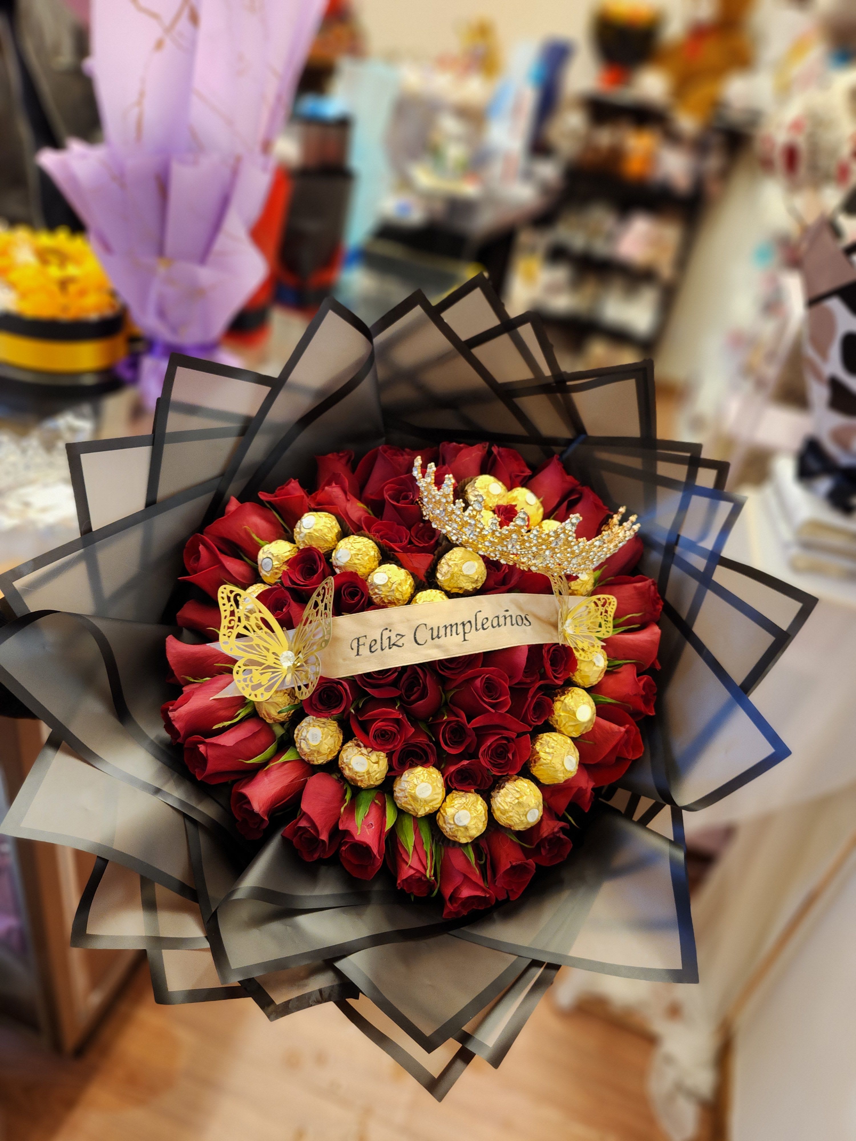 Bouquet of red roses with gold chocolates and a birthday ribbon