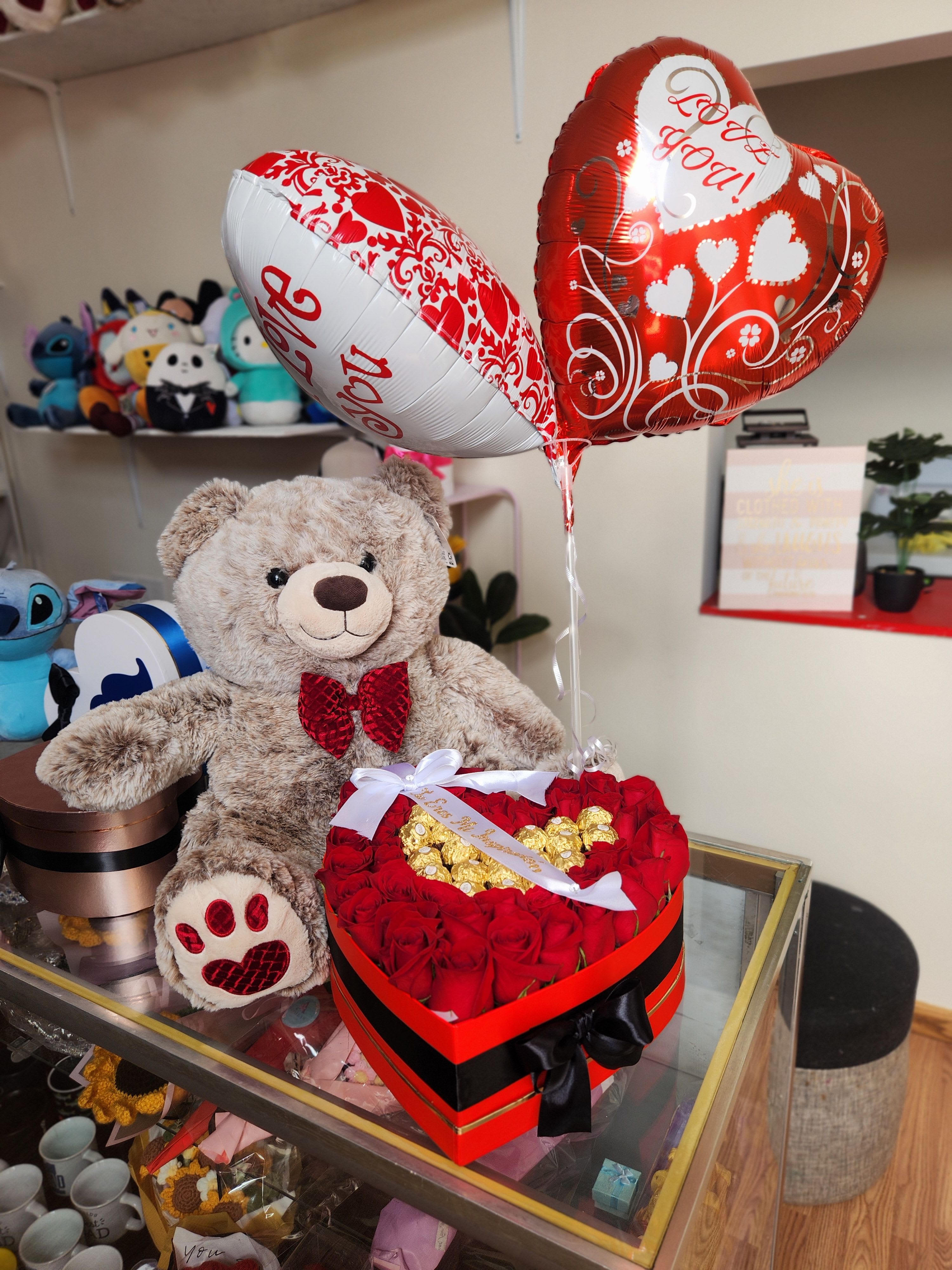 Heart-shaped rose box with teddy bear and Valentine balloons