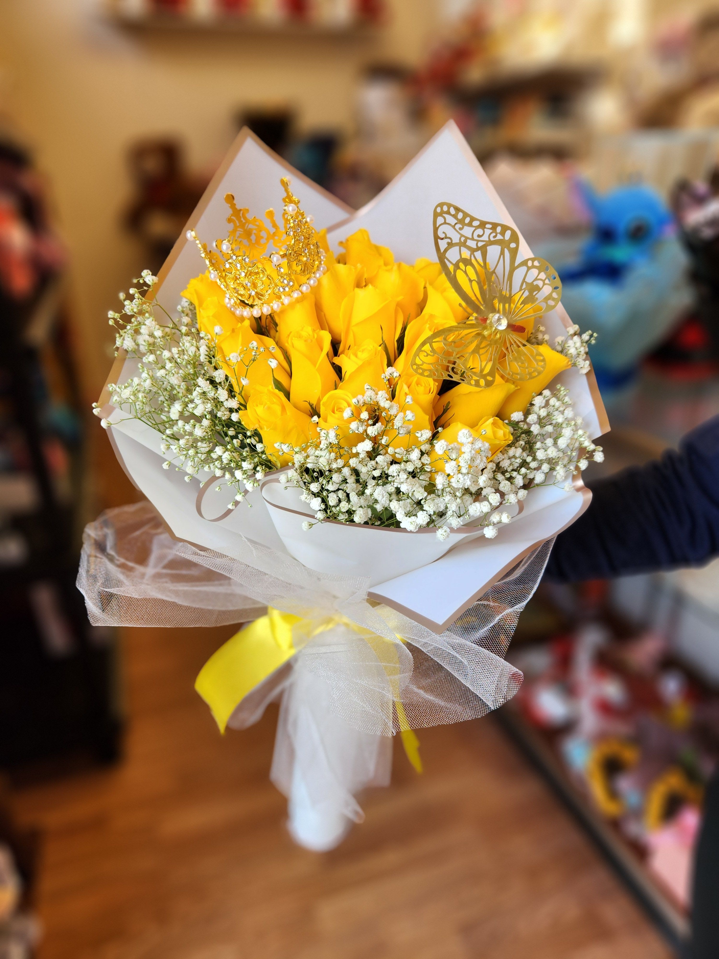 Yellow rose bouquet with baby’s breath and gold butterfly accents