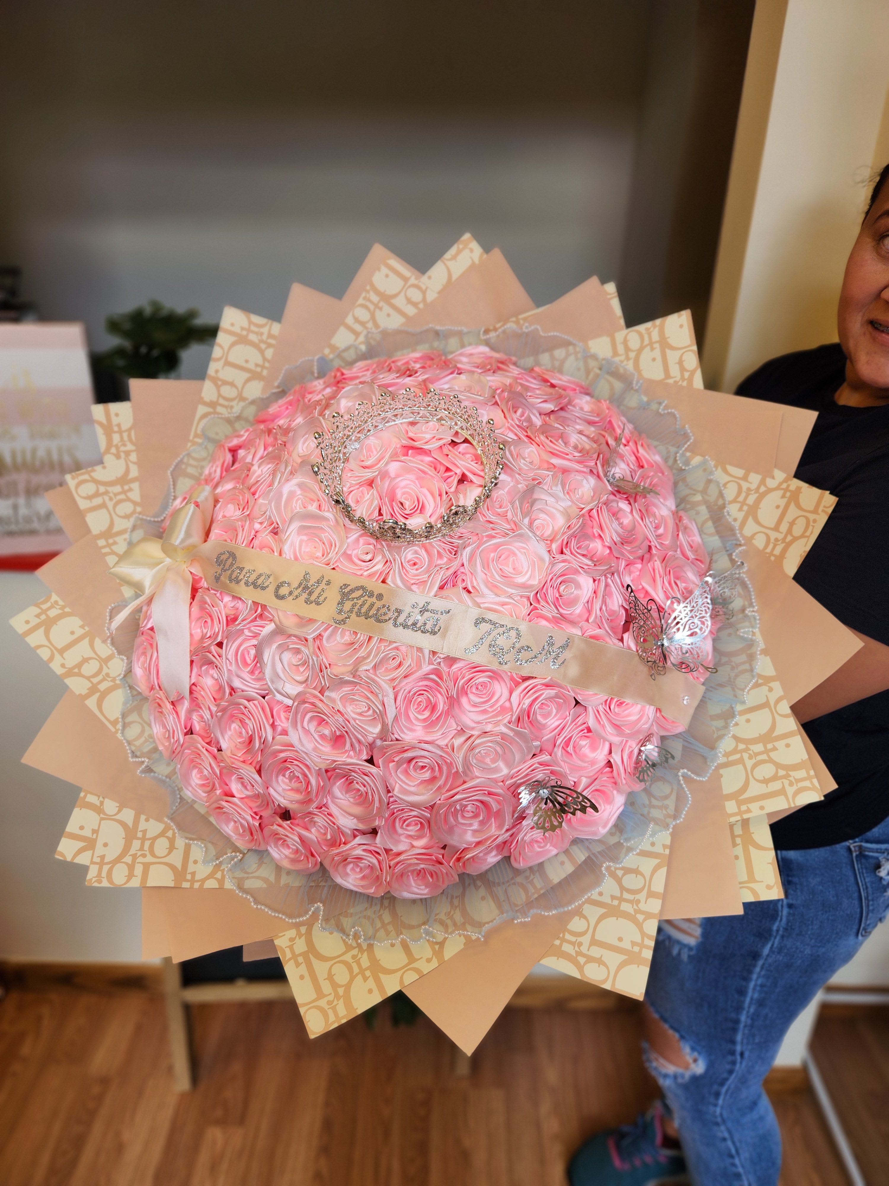 Large bouquet of pink roses with a tiara and ribbon