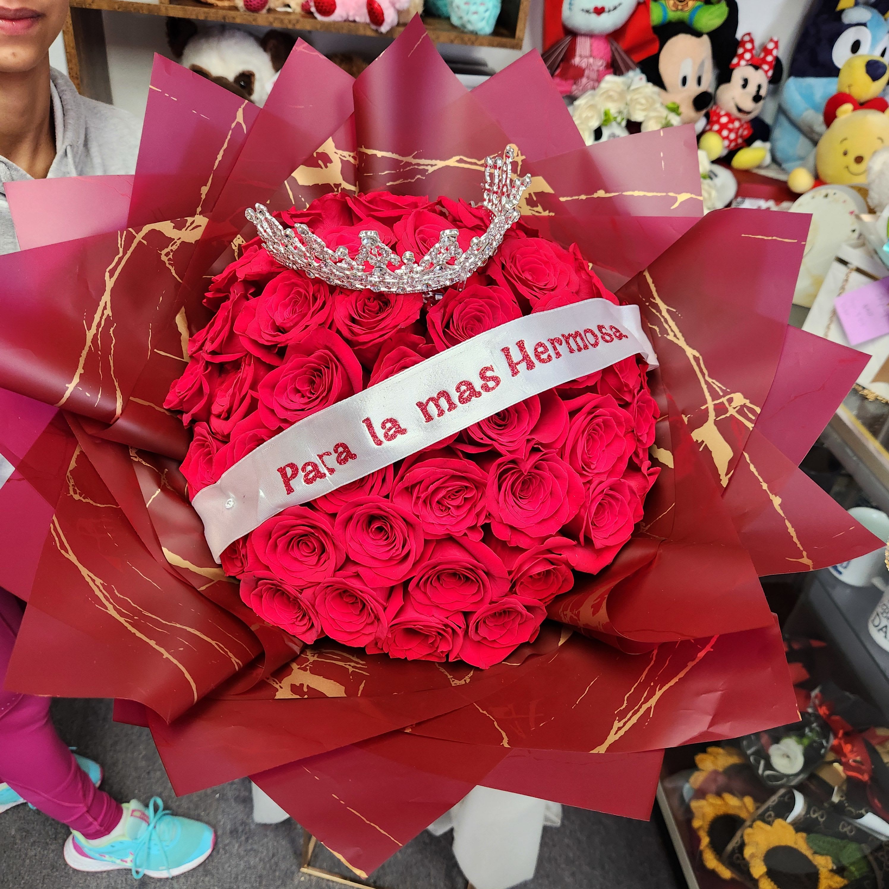 Bouquet of red roses with a jeweled crown and ribbon