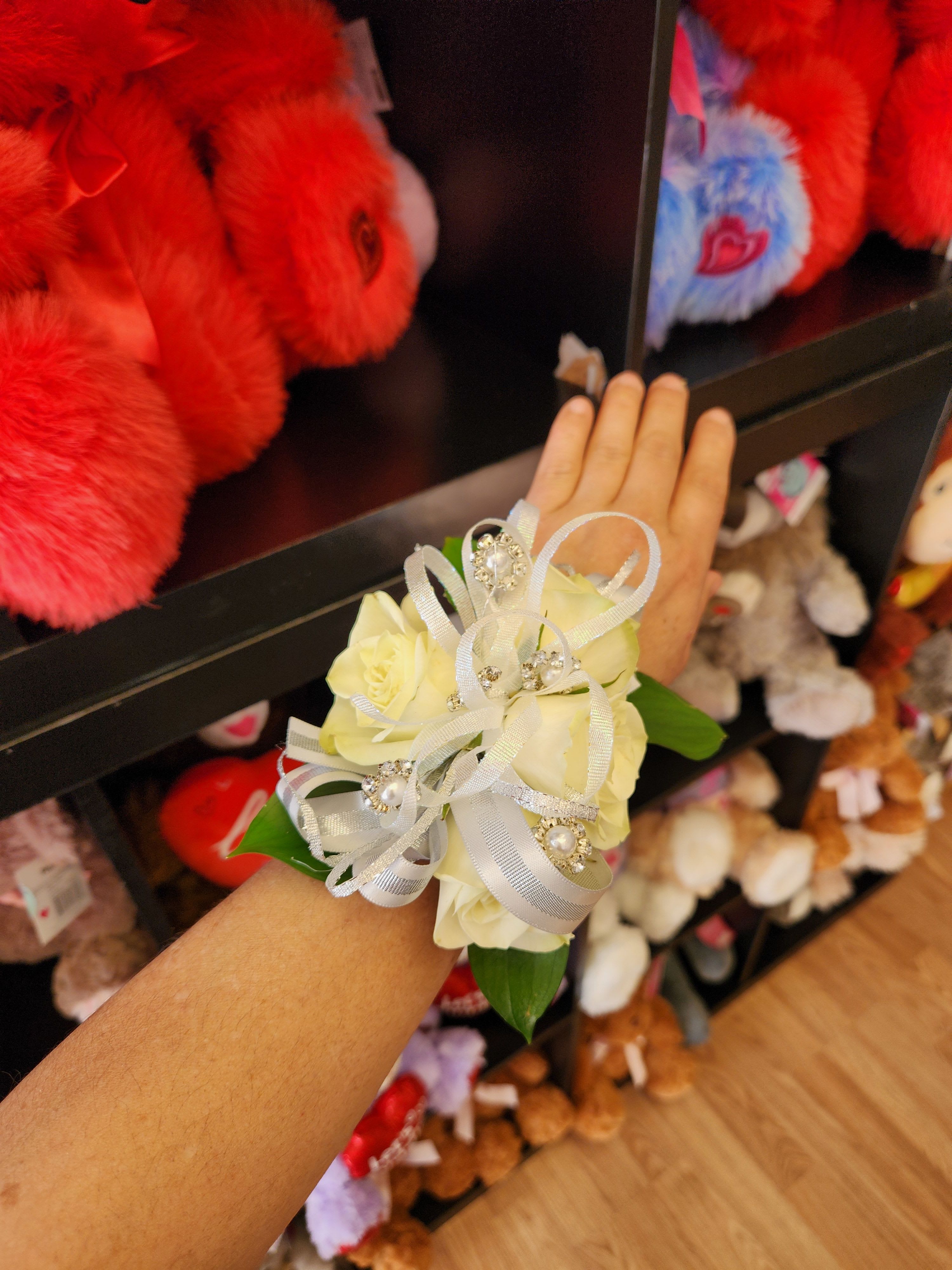 White rose wrist corsage with silver ribbon and rhinestone accents