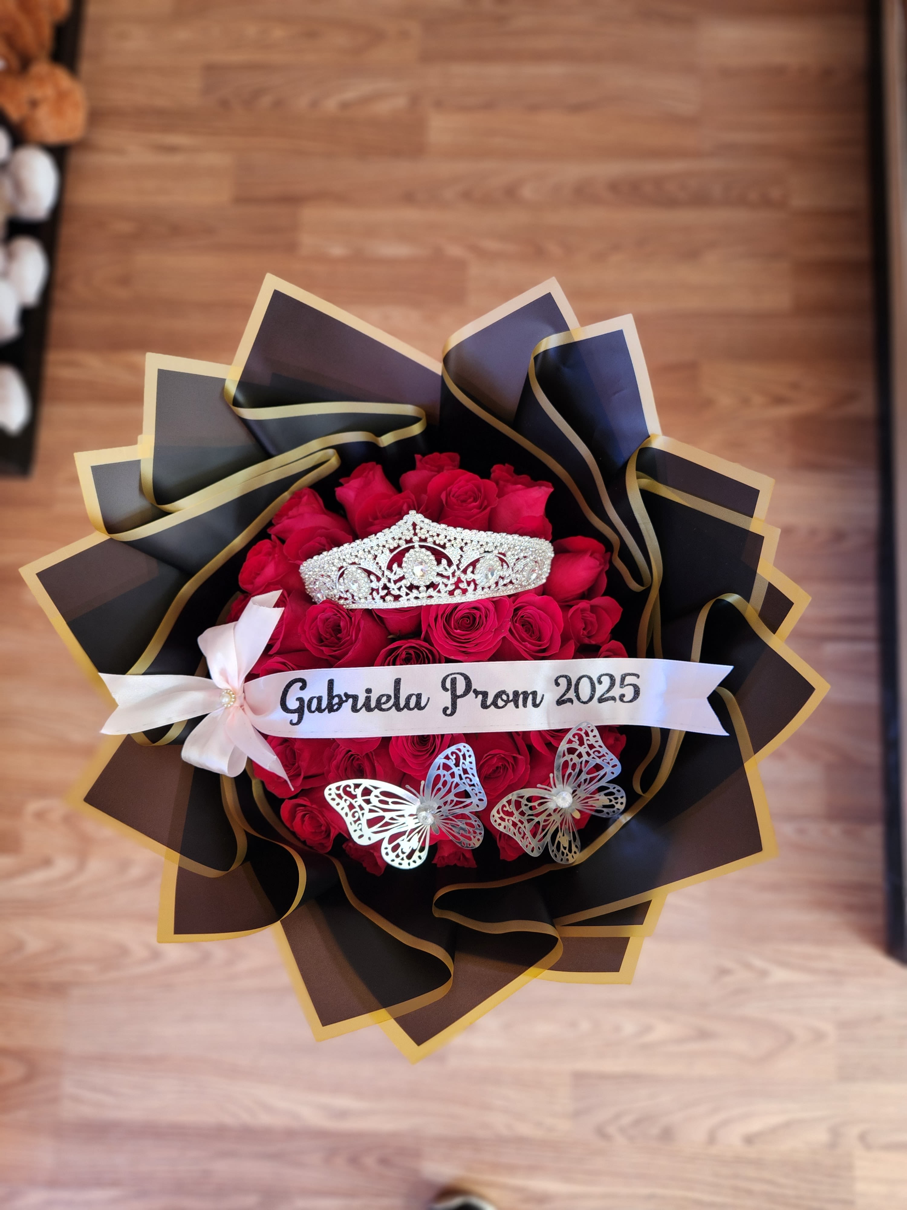 Red rose bouquet with a tiara and prom ribbon