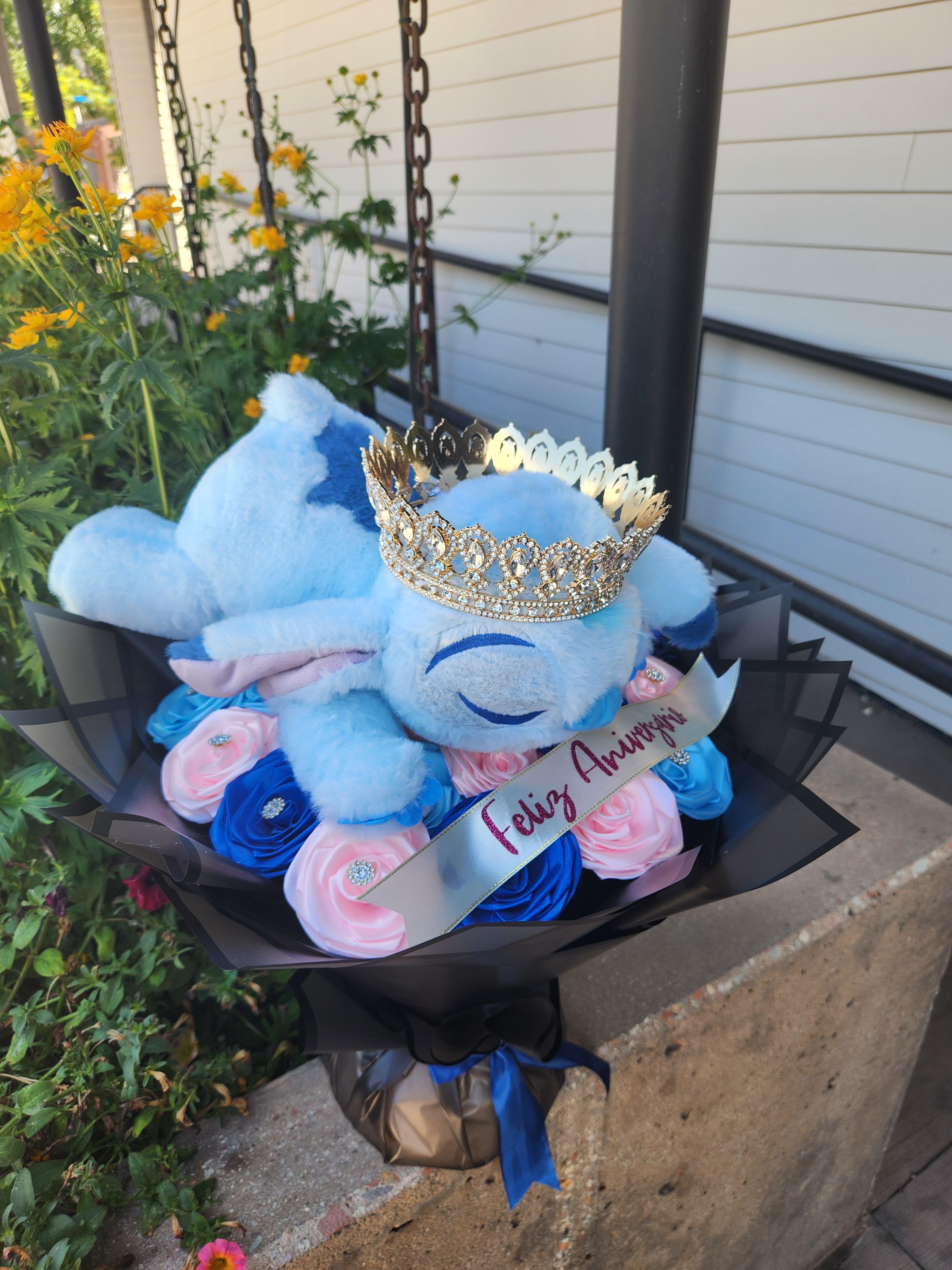 Blue teddy bear bouquet with pink and blue roses and a jeweled crown